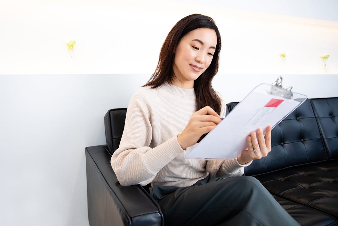 patient writing on a clipboard