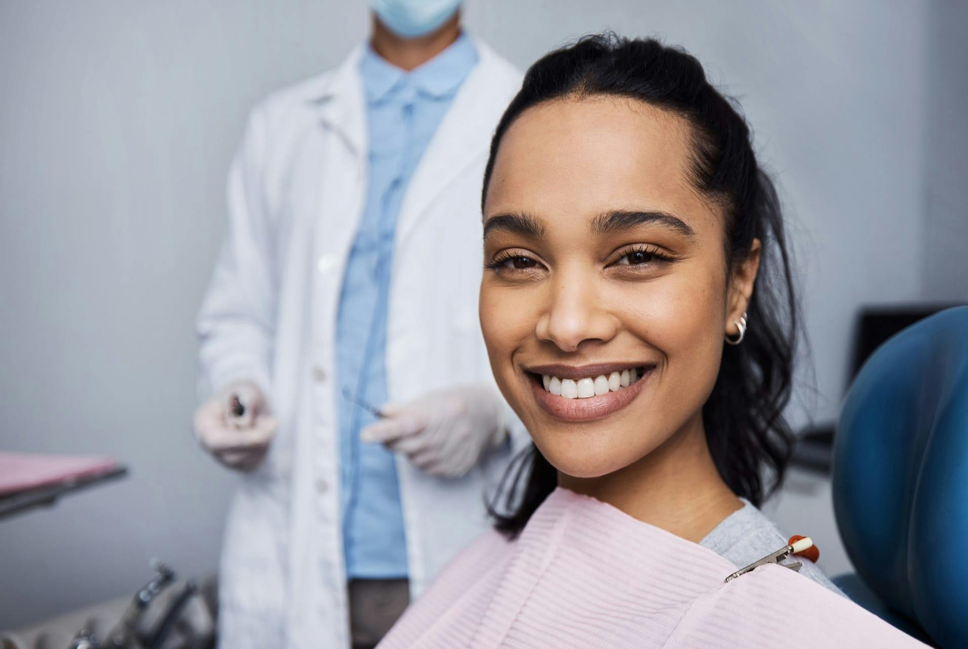 woman in dentist chair, smiling