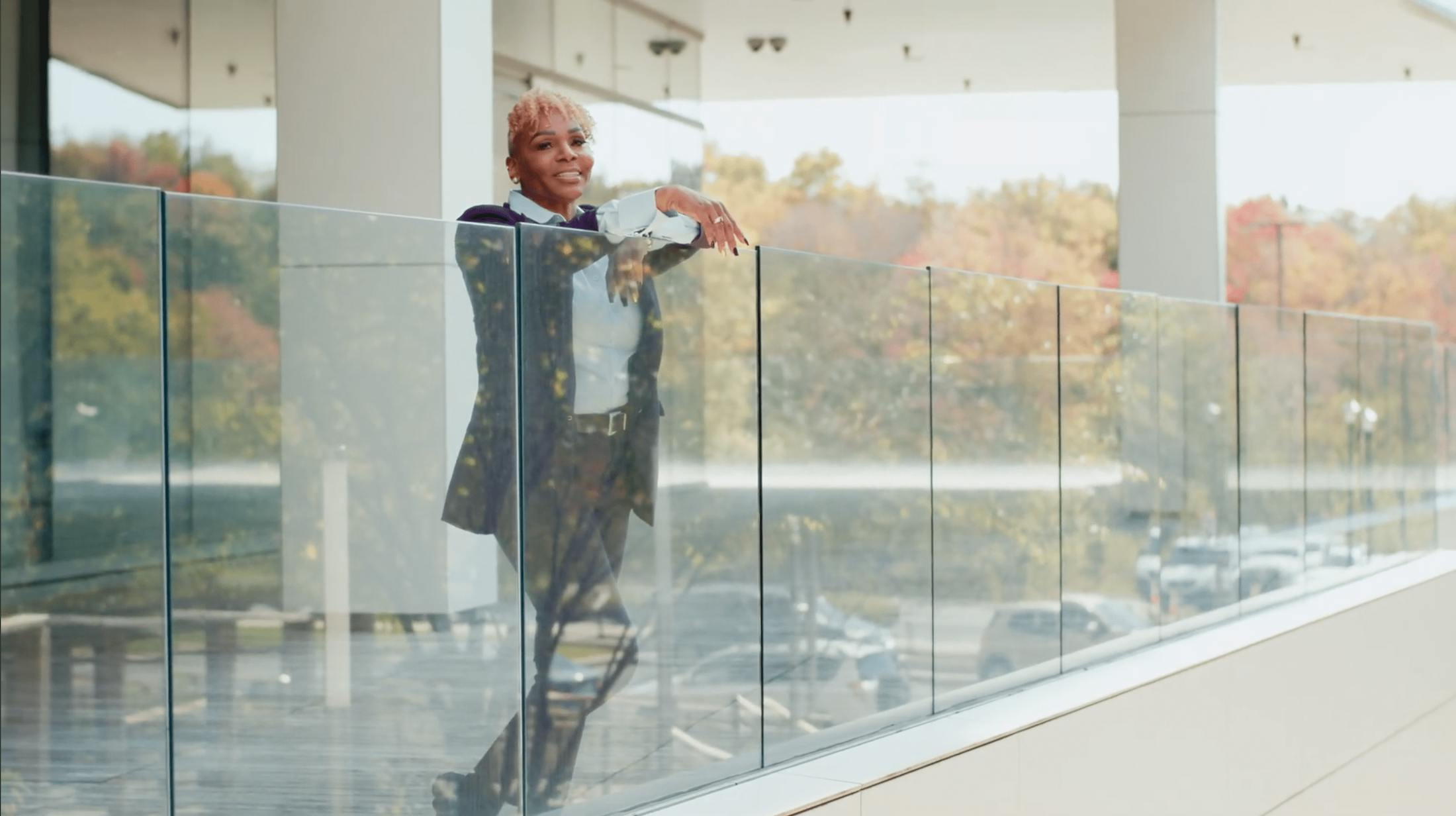 Woman resting on glass wall