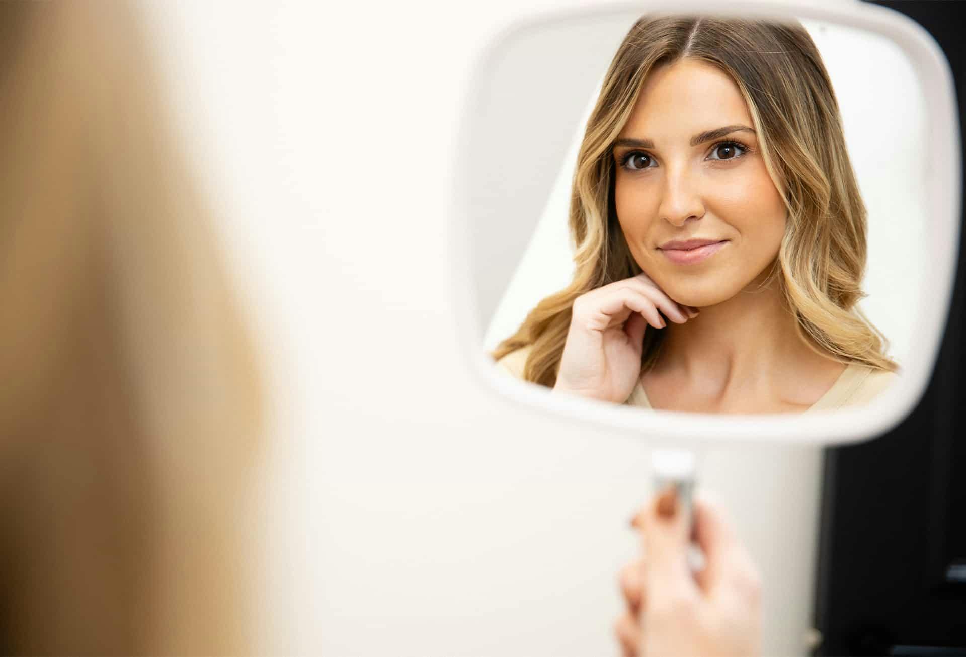 Woman looking into mirror