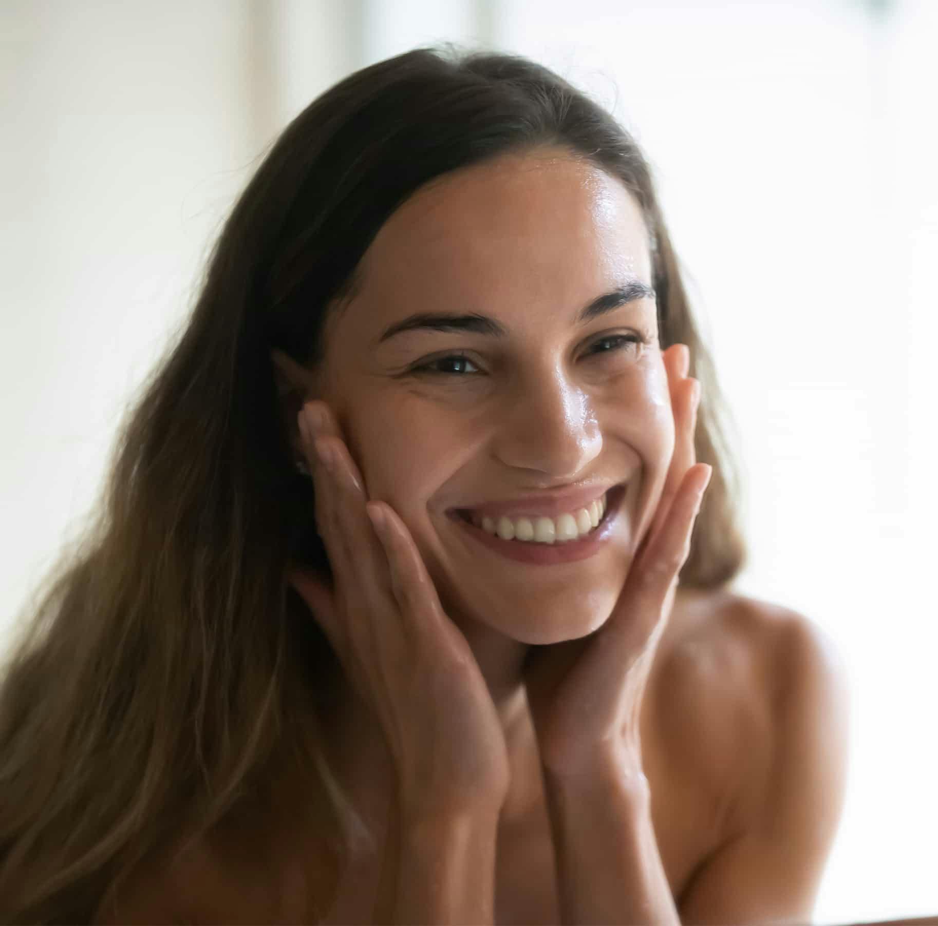 Woman smiling touching face