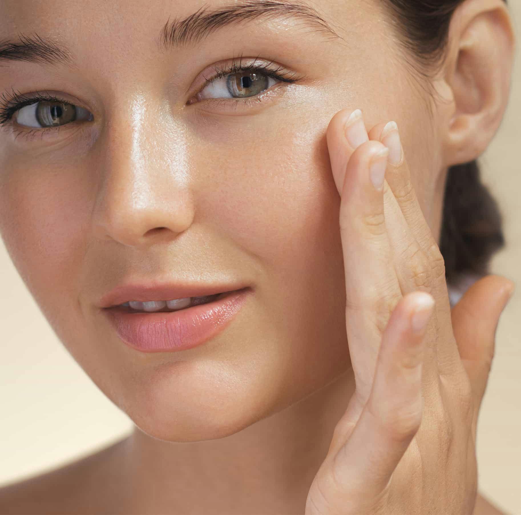 Woman rubbing cream on face