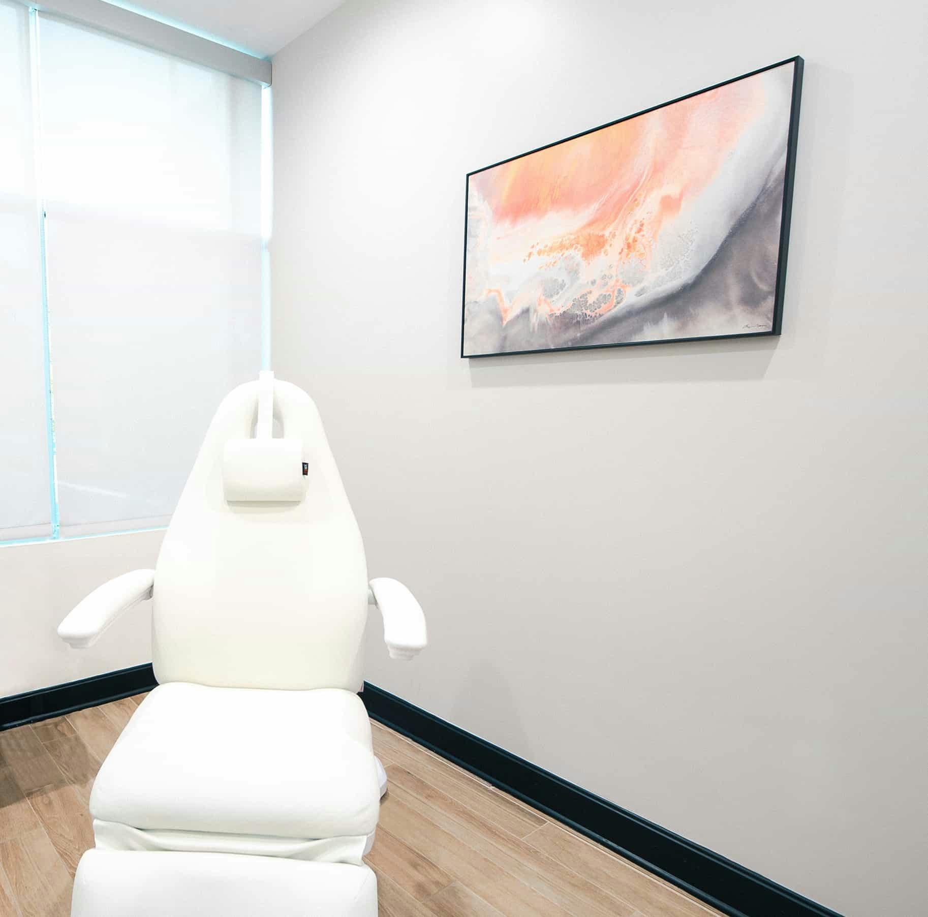 Chair in room with artwork on wall