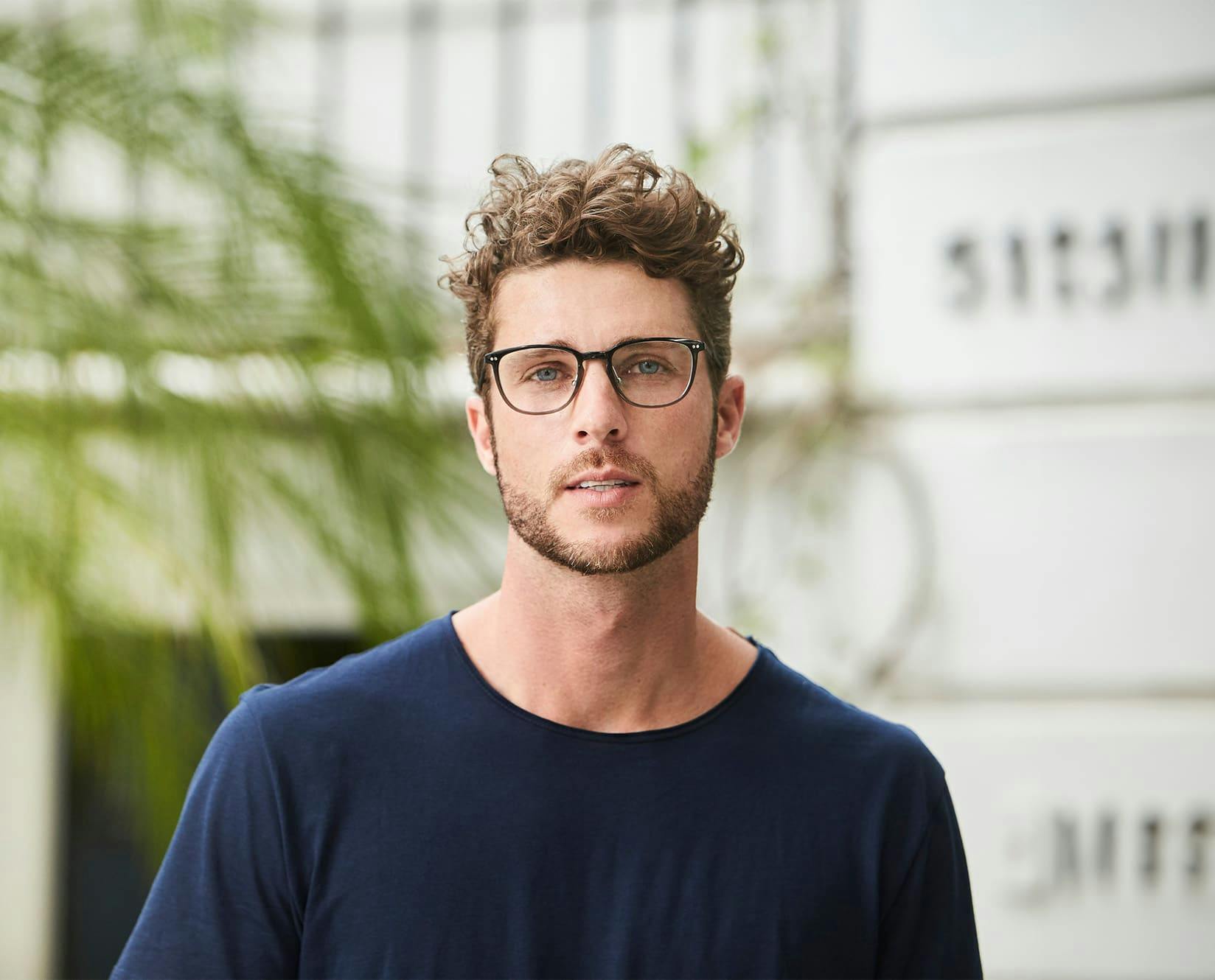 man with facial hair wearing glasses