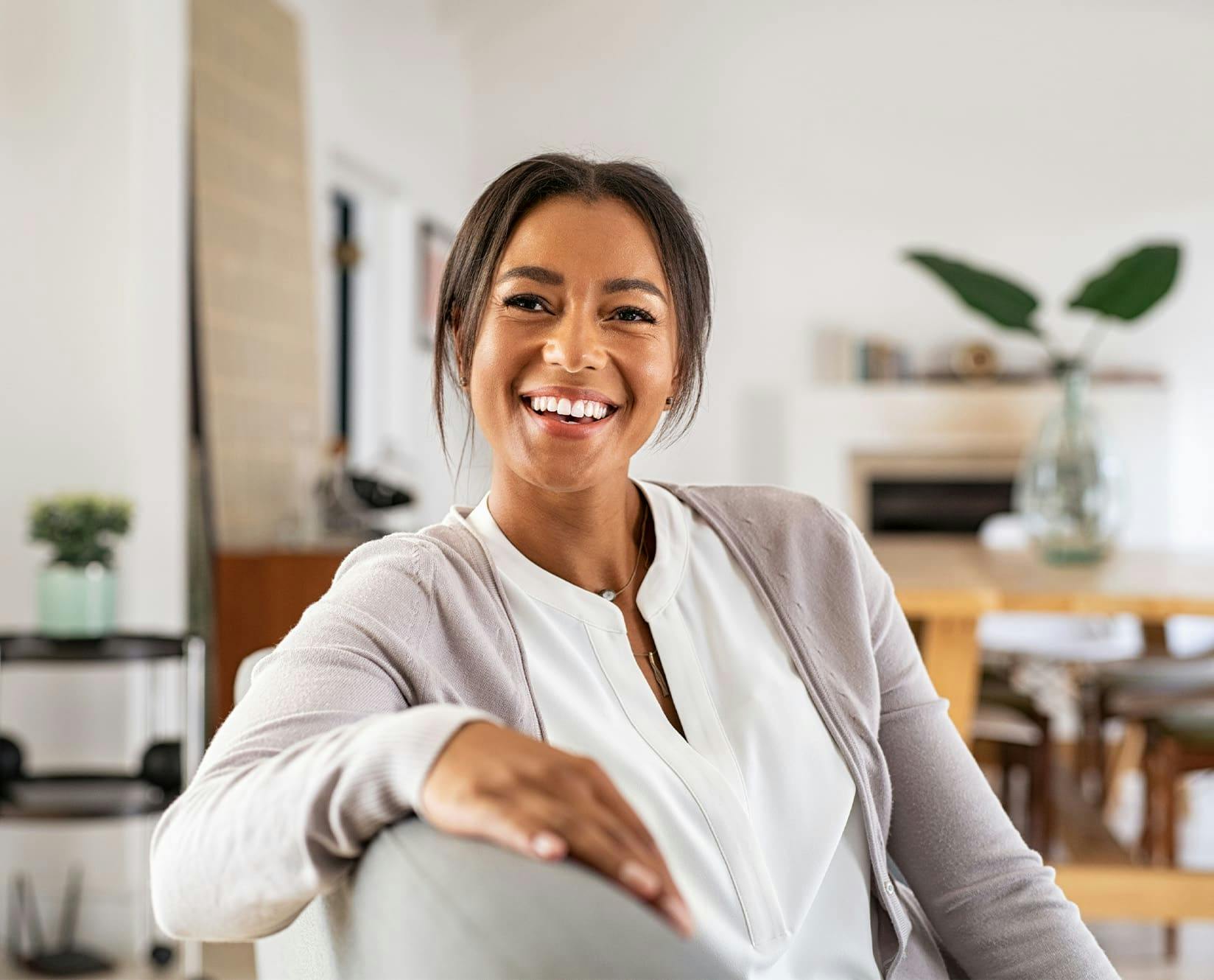 woman sitting down in a chair smiling