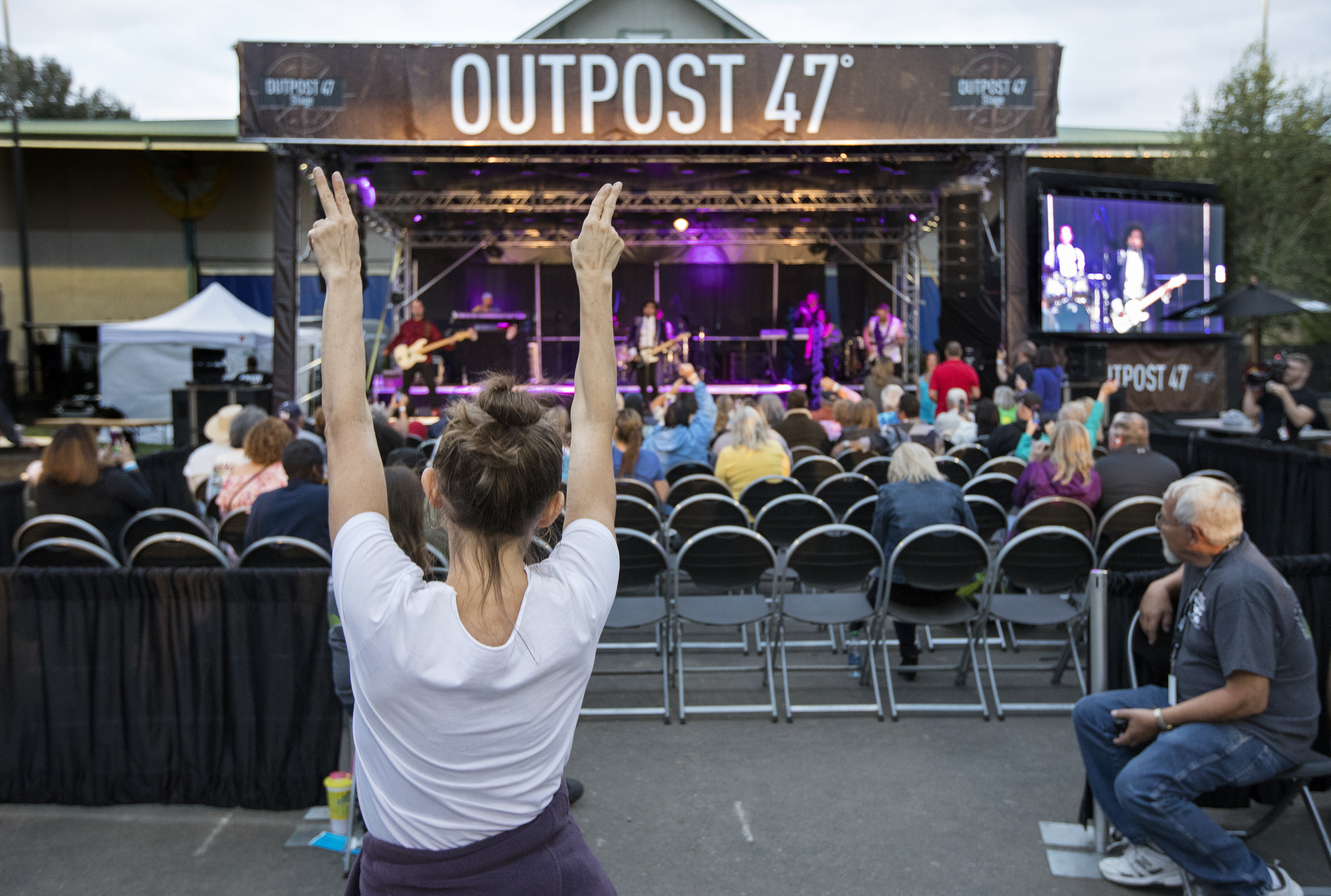 A crowd watching a music performance on the Outpost 17 stage.