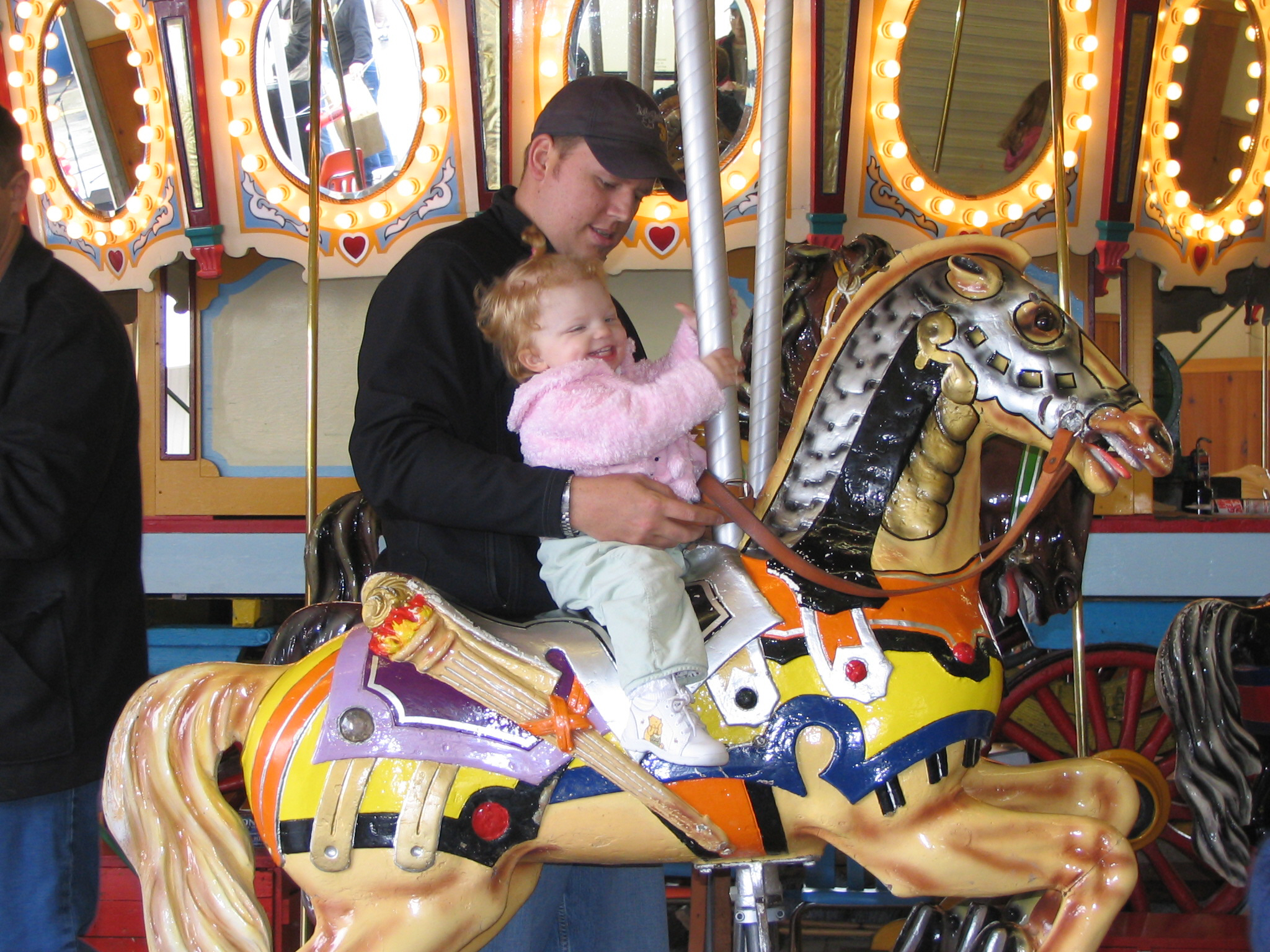 a child and family member at the antique carousel