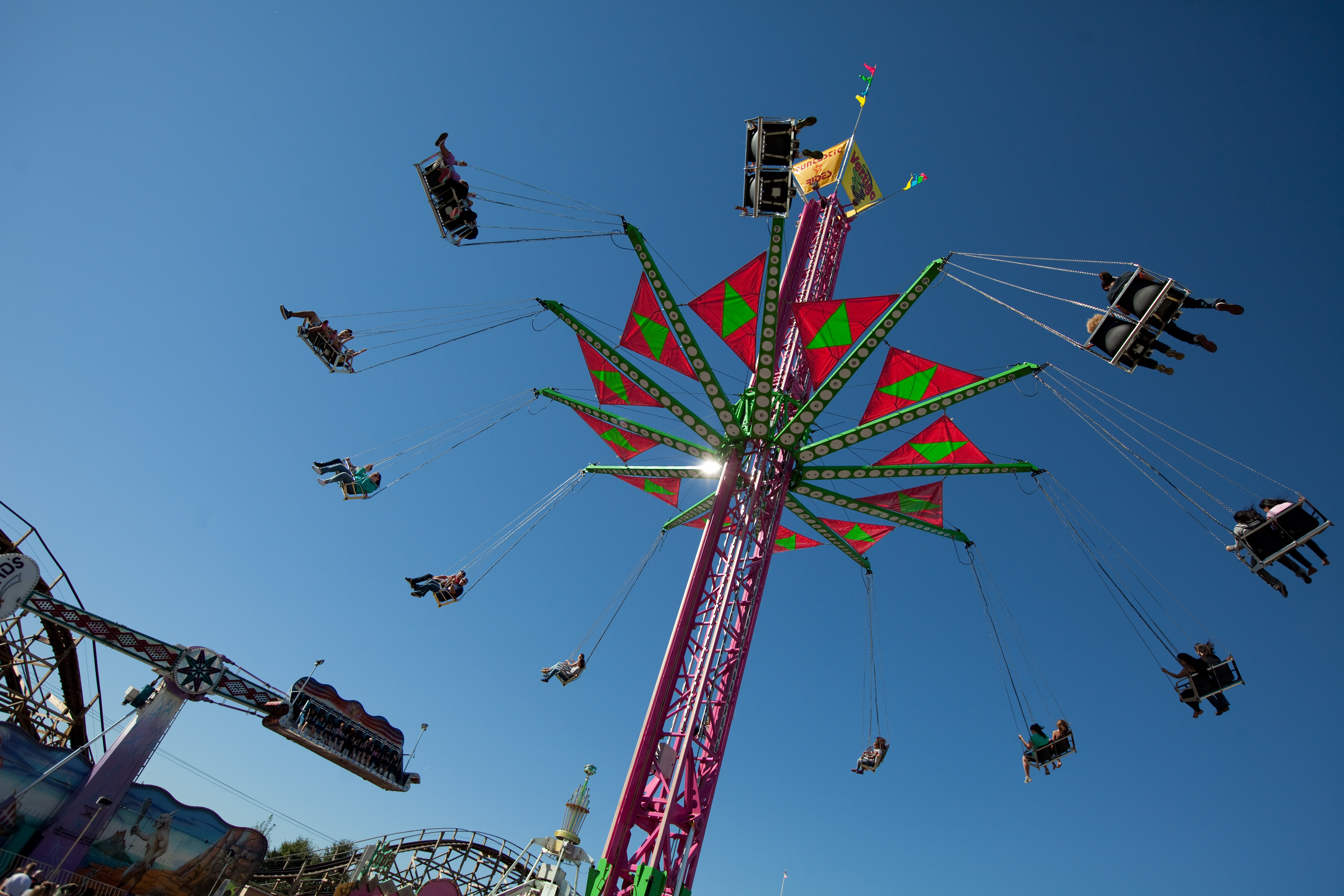 A swing ride spinning high in the air.