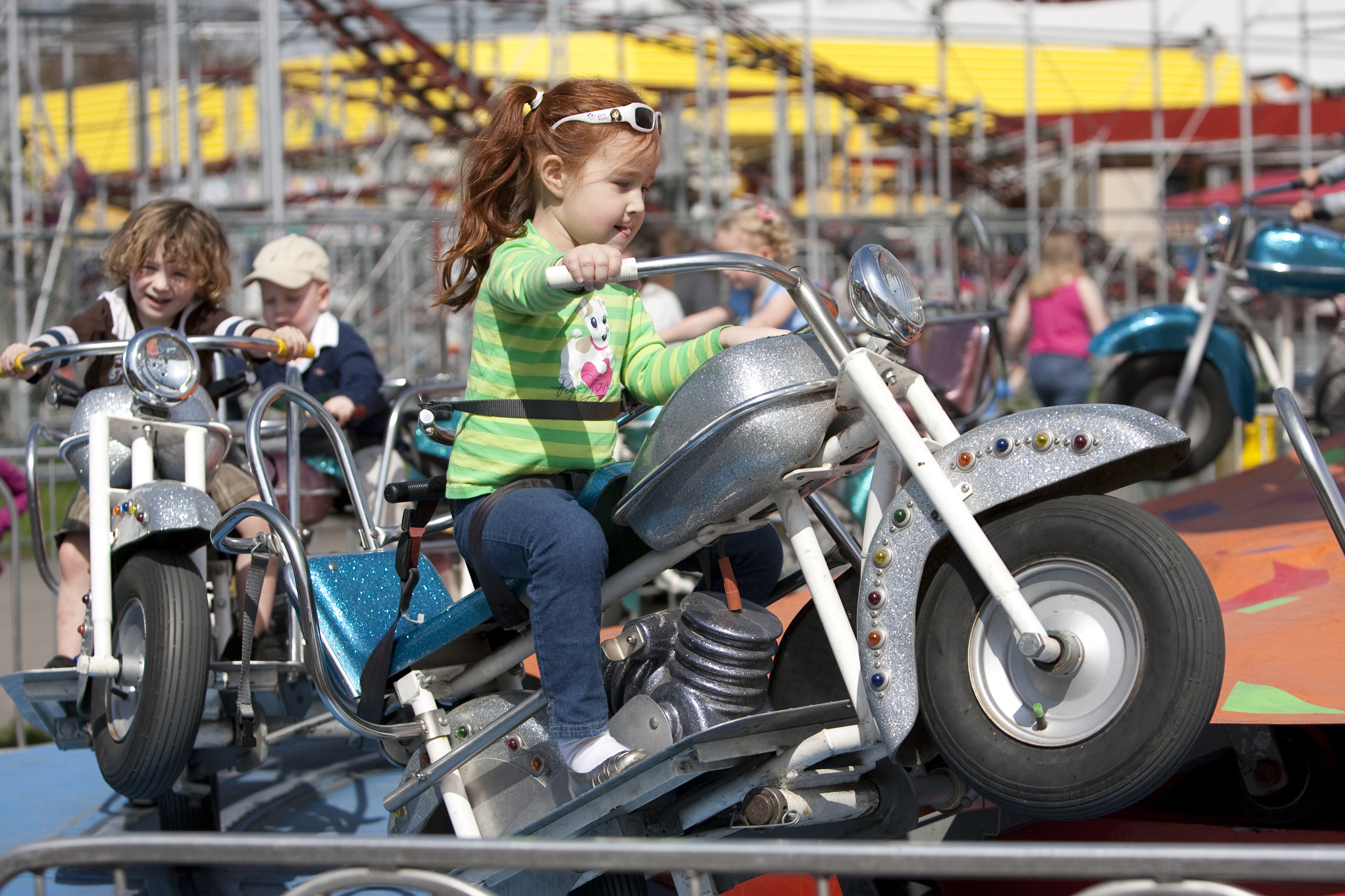 A spinning ride with mini motorcycles for small children