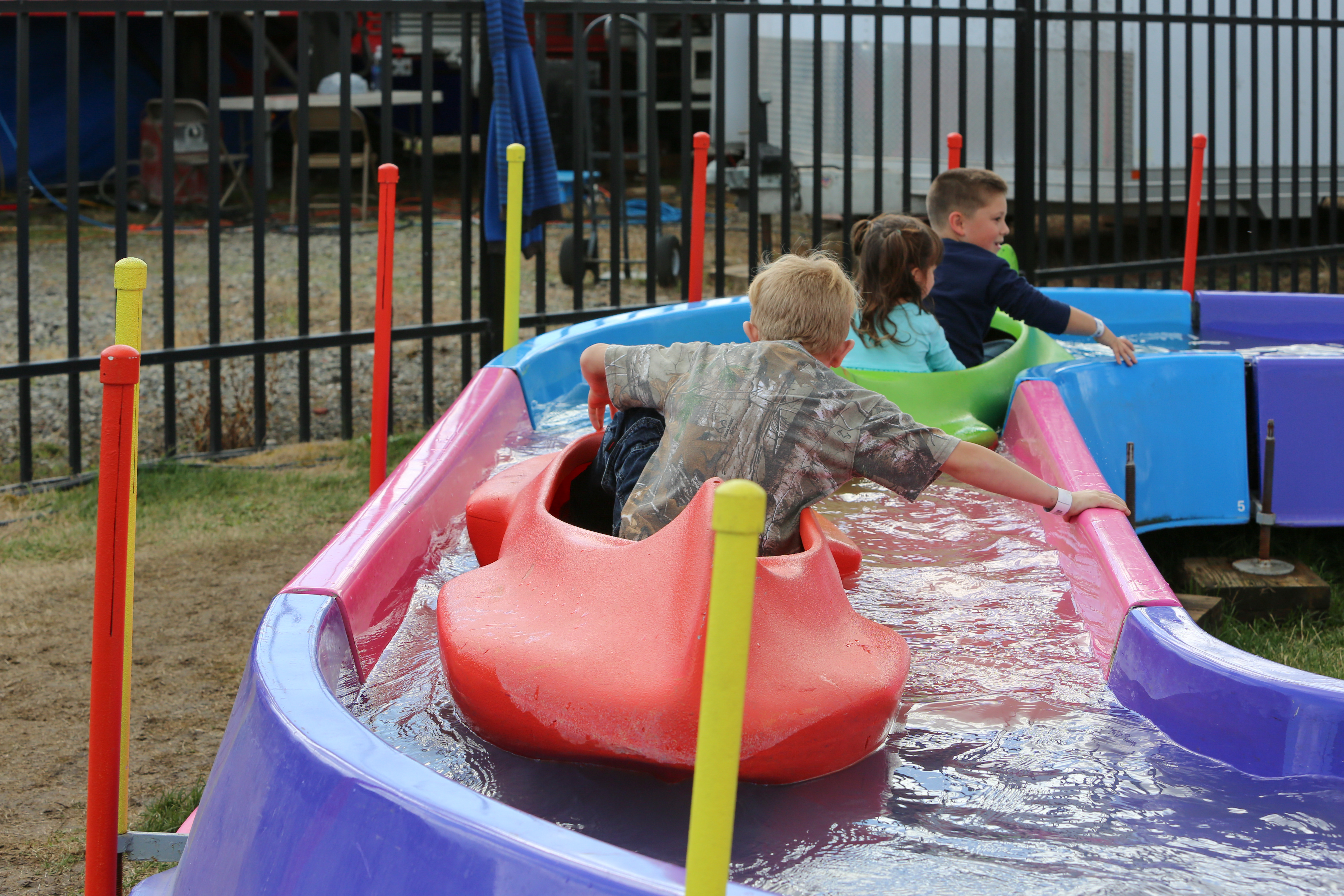Kiddos ride a gentle water boat course