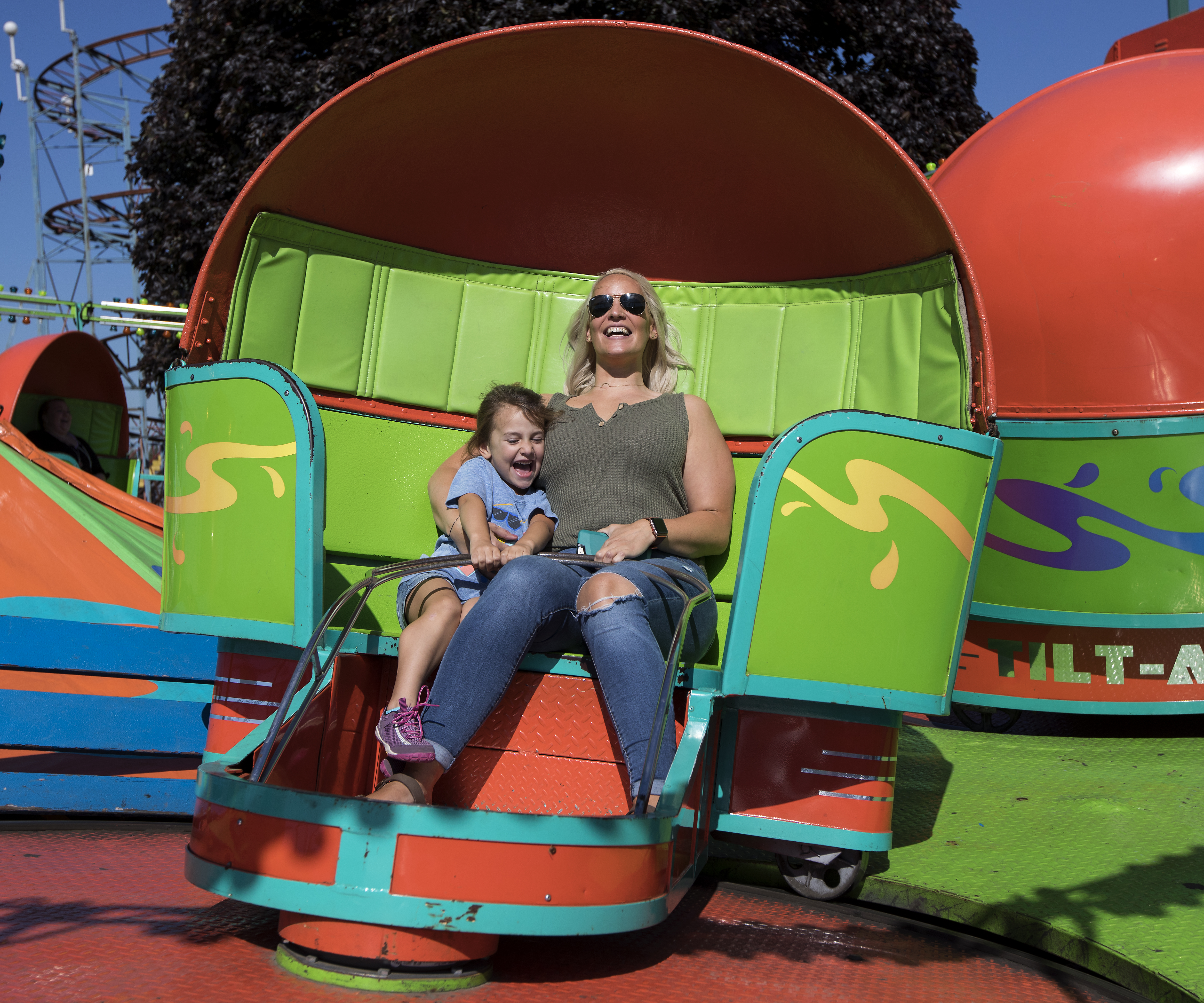 Riders enjoy the Title-A-Whirl, a spinning ride with colorful orb-shaped cars.