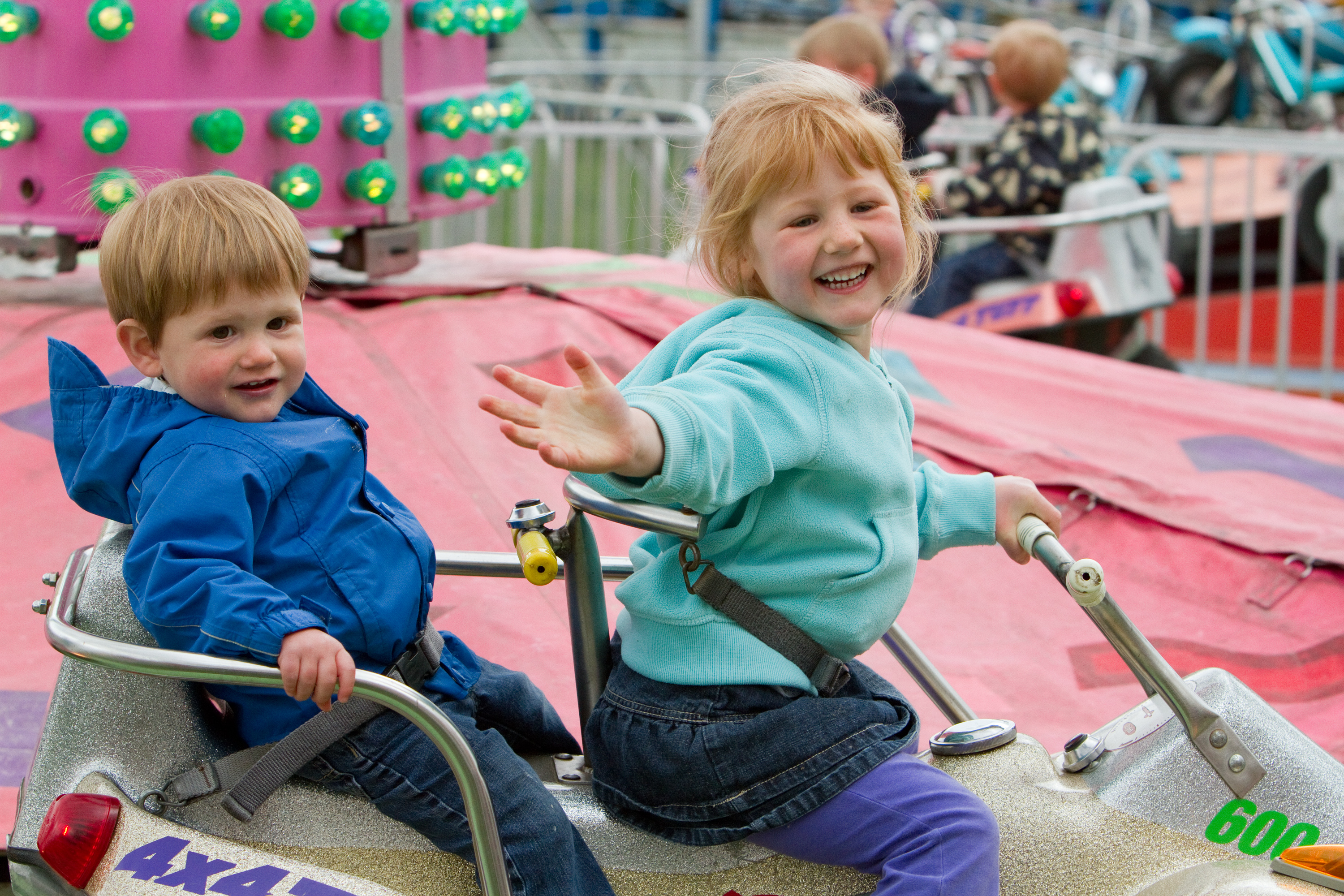 Small kids ride the Quad Racer, a gentle ride with quad-themed cars.