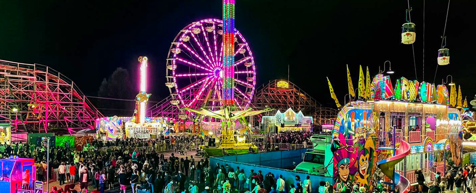 Midway at night lit up with carnival rides lights