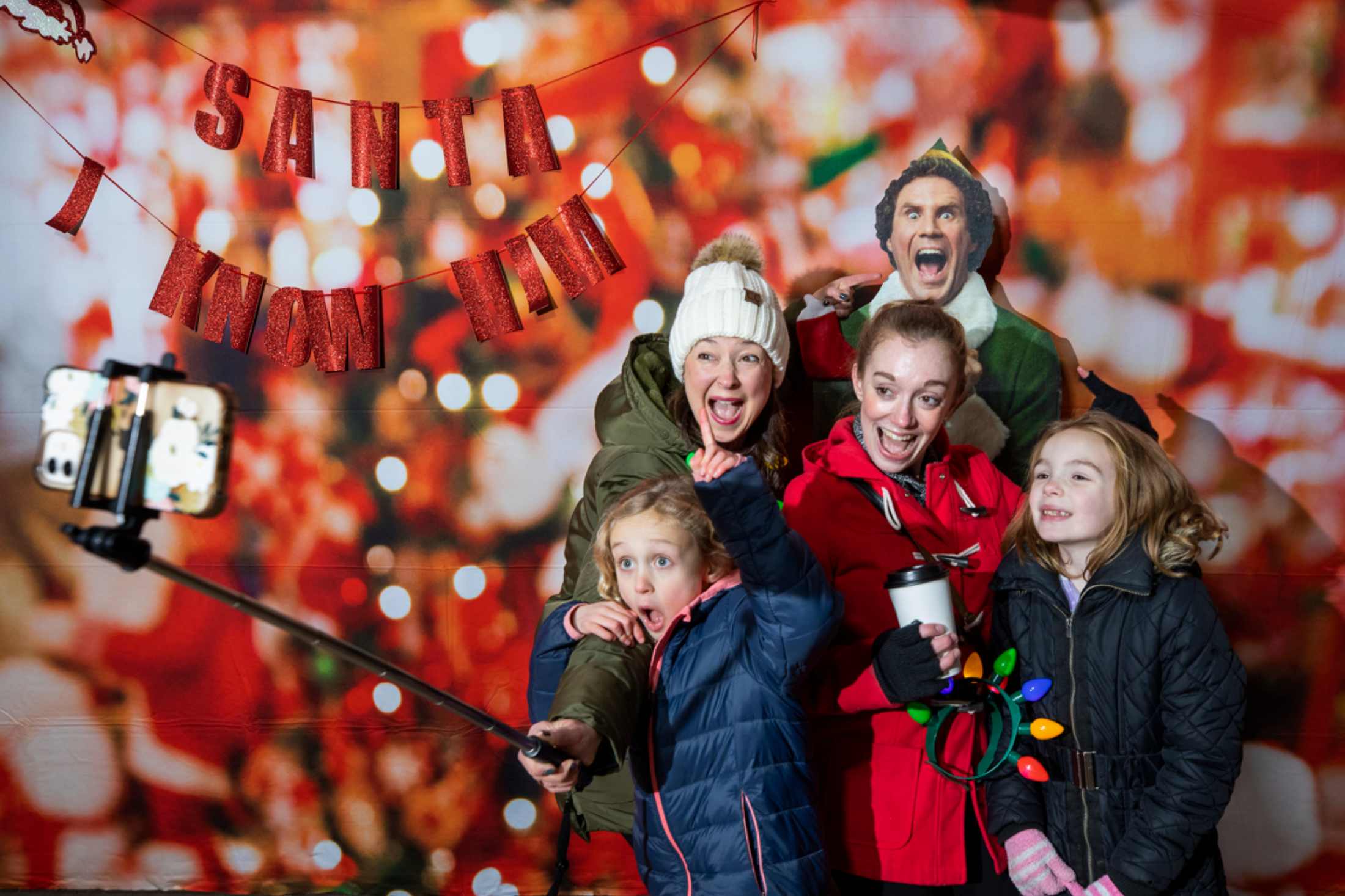 A family poses at the holiday selfie station