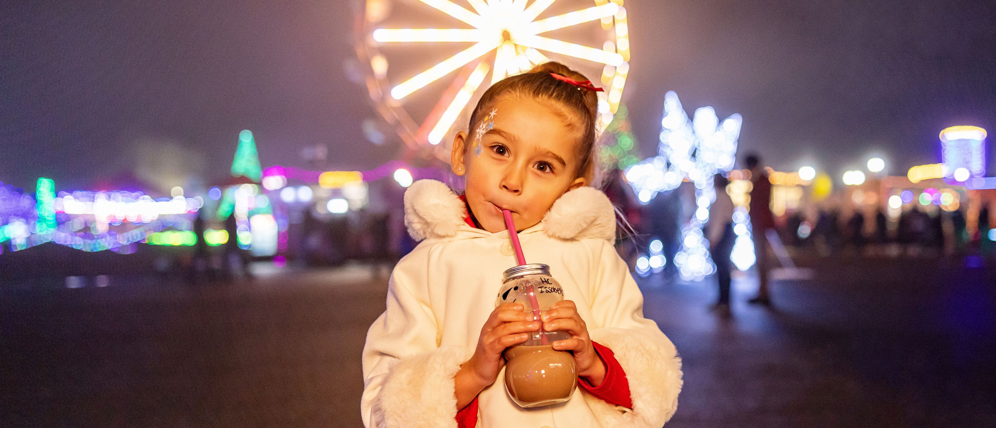 Girl with beverage at Holiday Magic