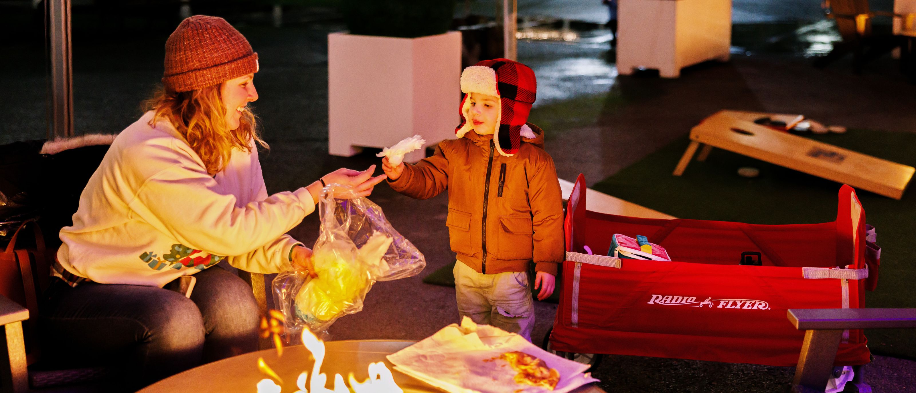 Mom and Son eating cotton candy at the Fireside Plaza at Holiday Magic