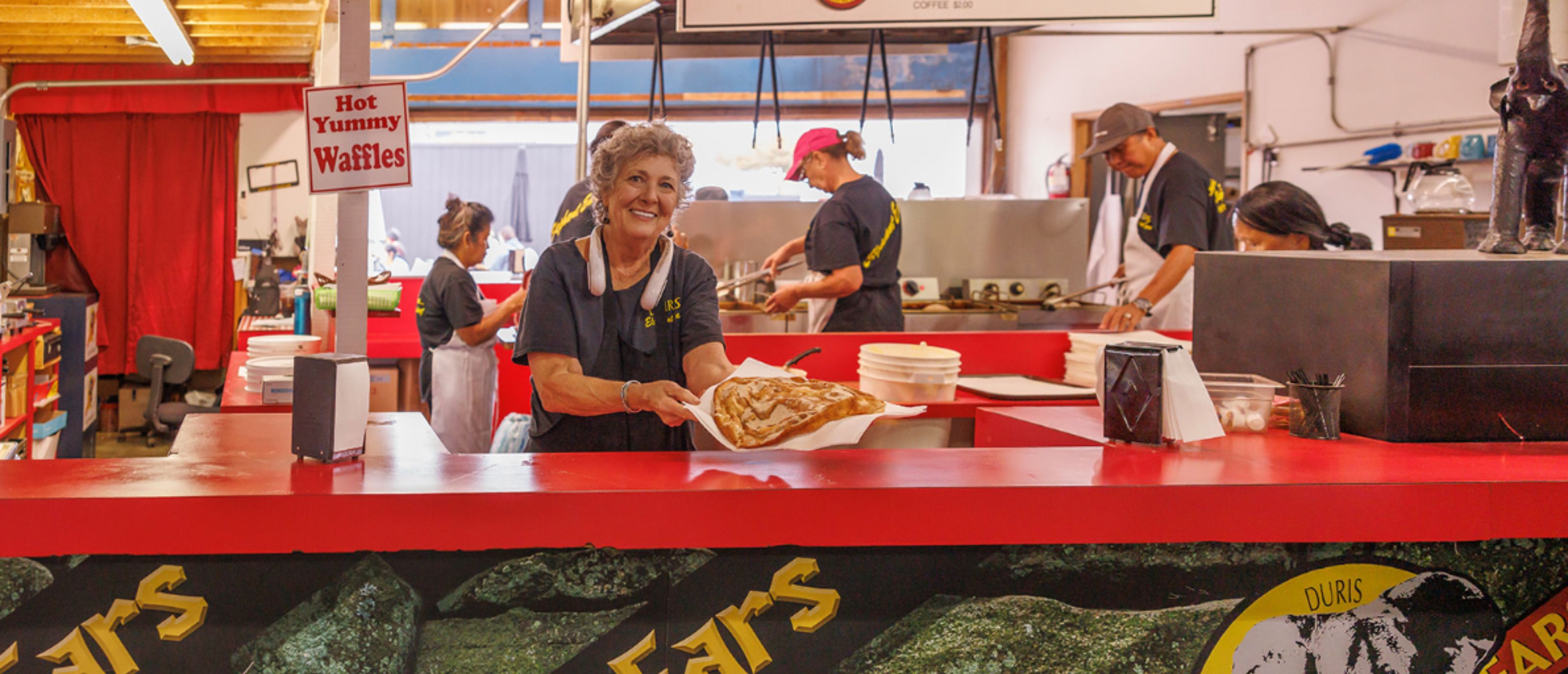 Woman holding elephant ear at Duris Concessions food booth