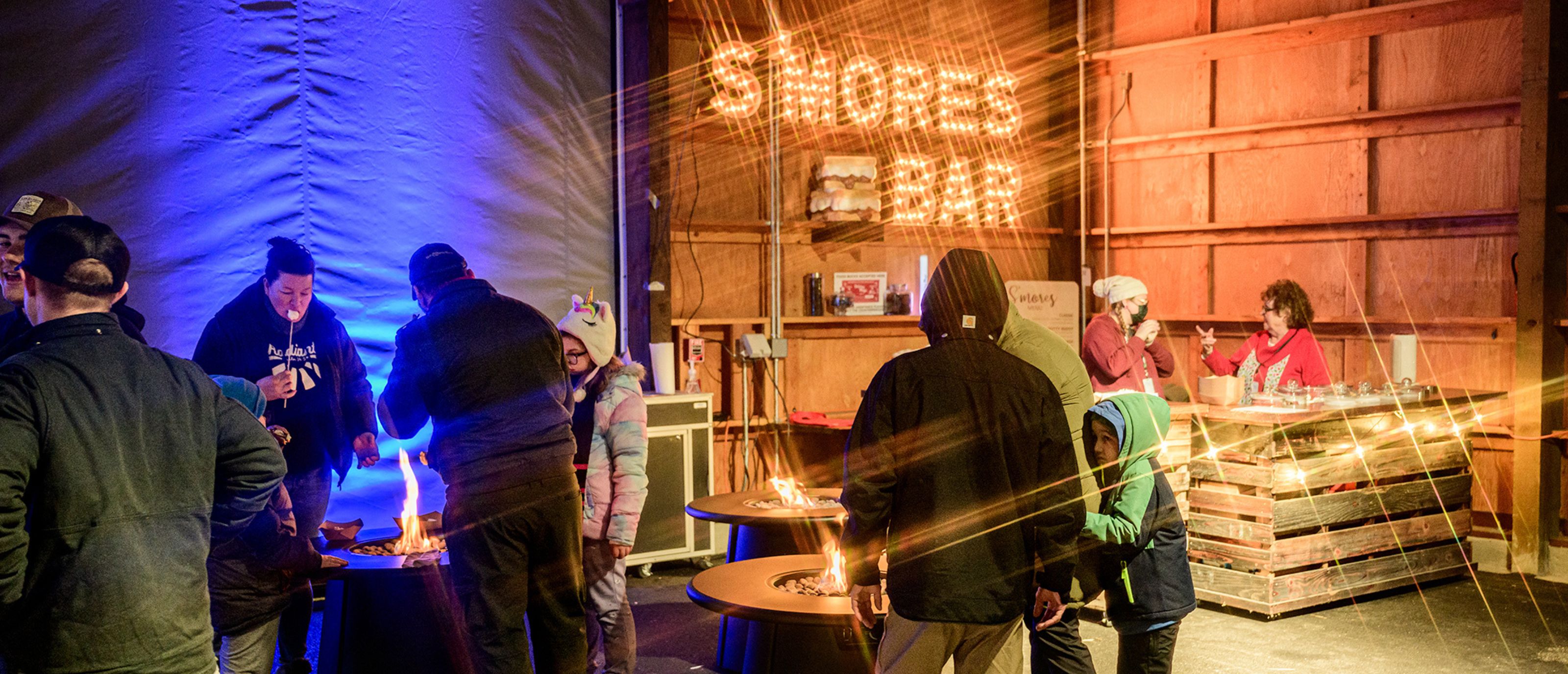 families enjoying the s'mores bar