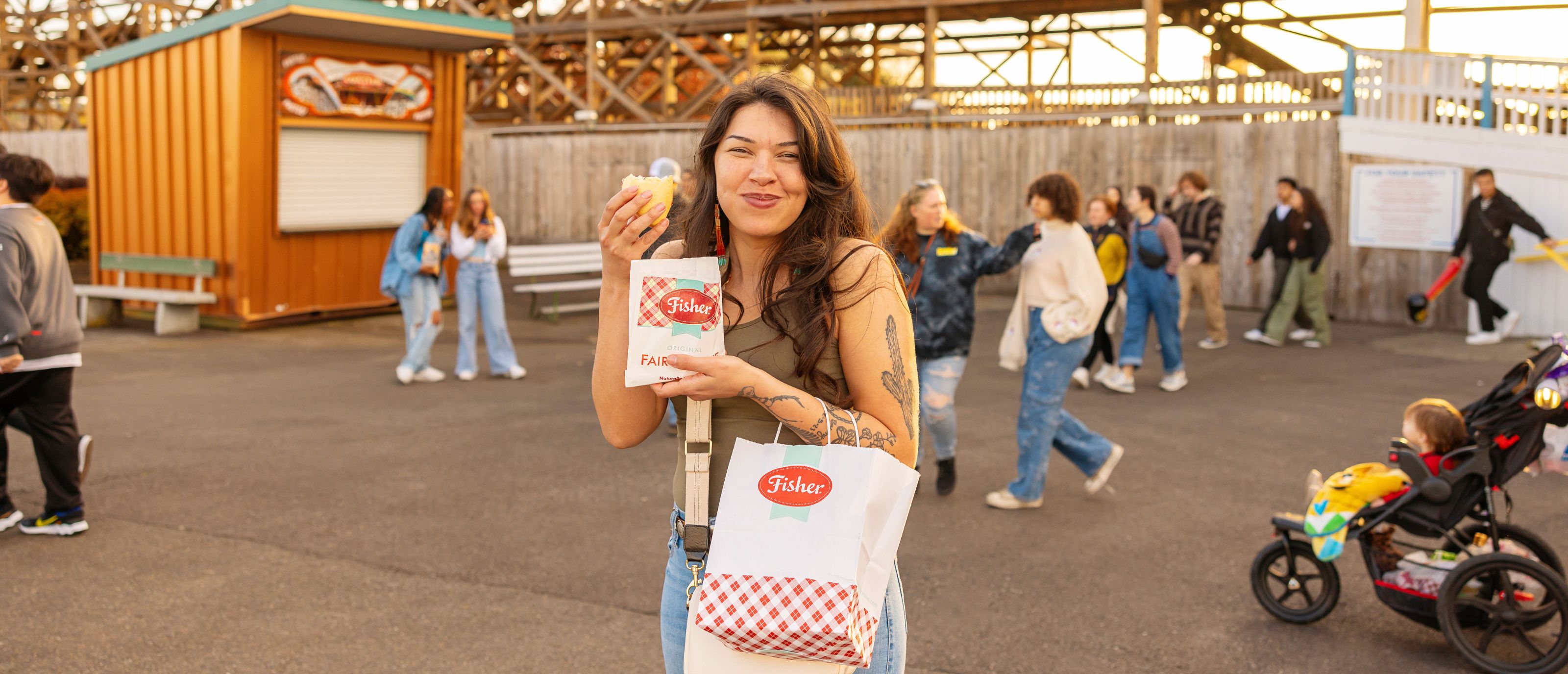 Woman eating fisher scone holding scone bag in front of classic coaster