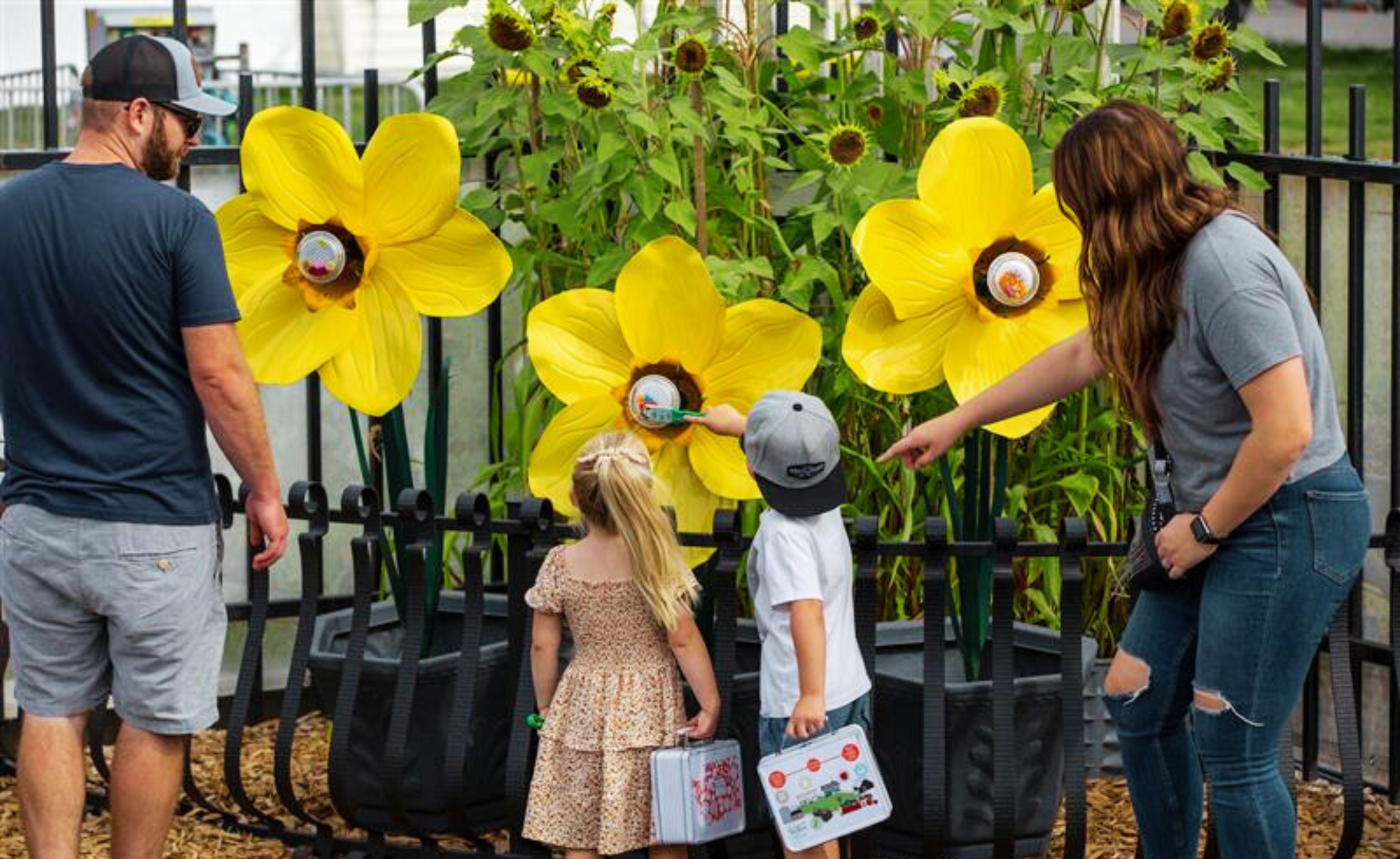 family at the backyard garden, pollinator flowers