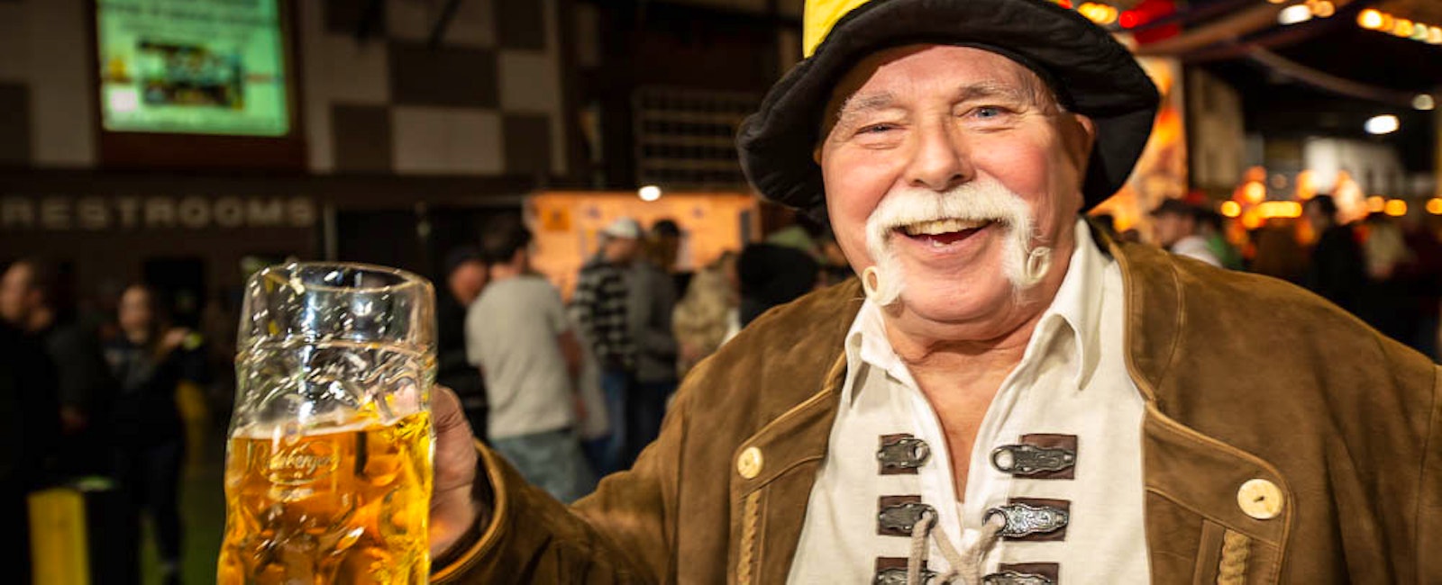 Man holding stein of bier at Oktoberfest NW