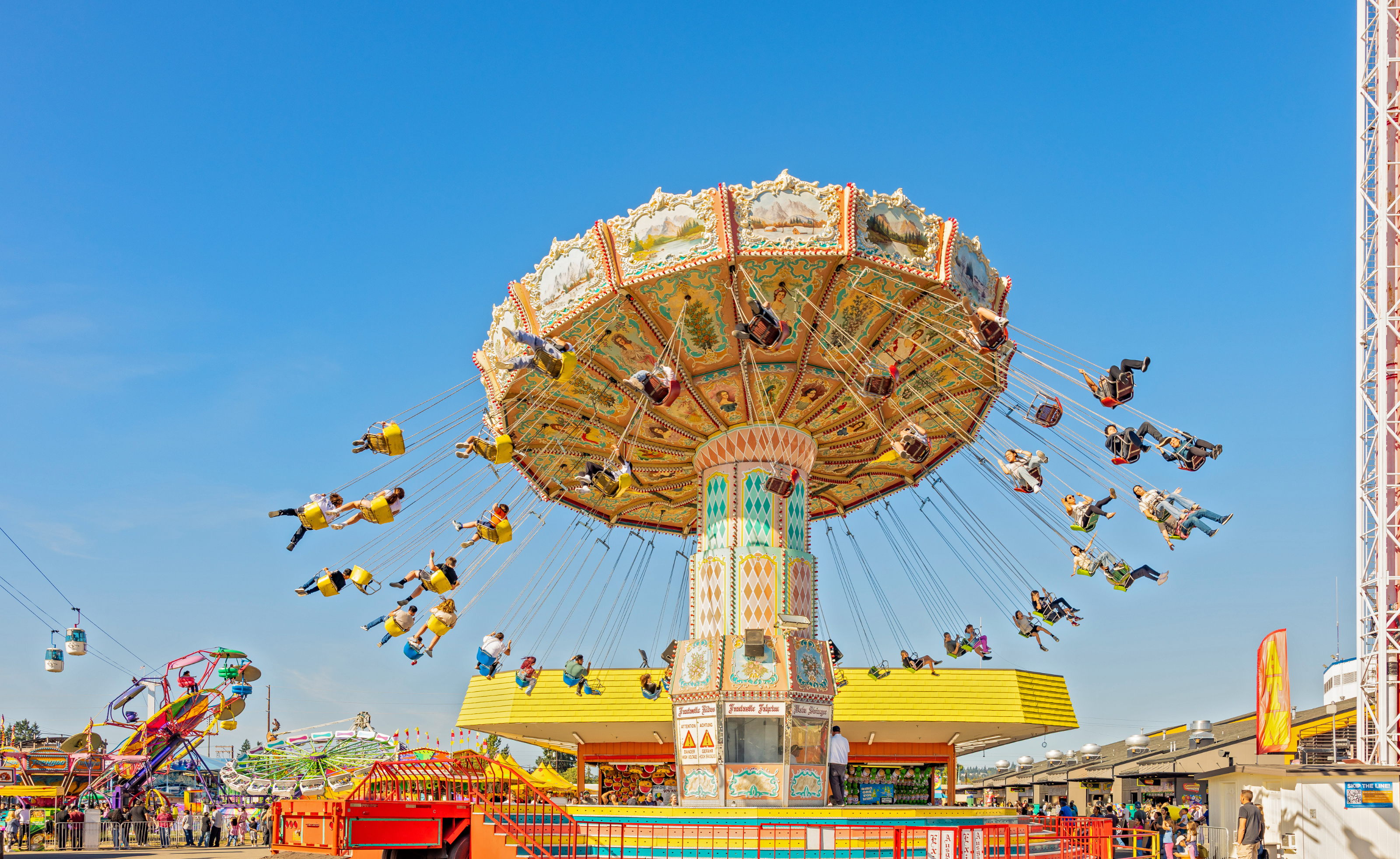 The swing ride at the Fair with a big blue sky in the background
