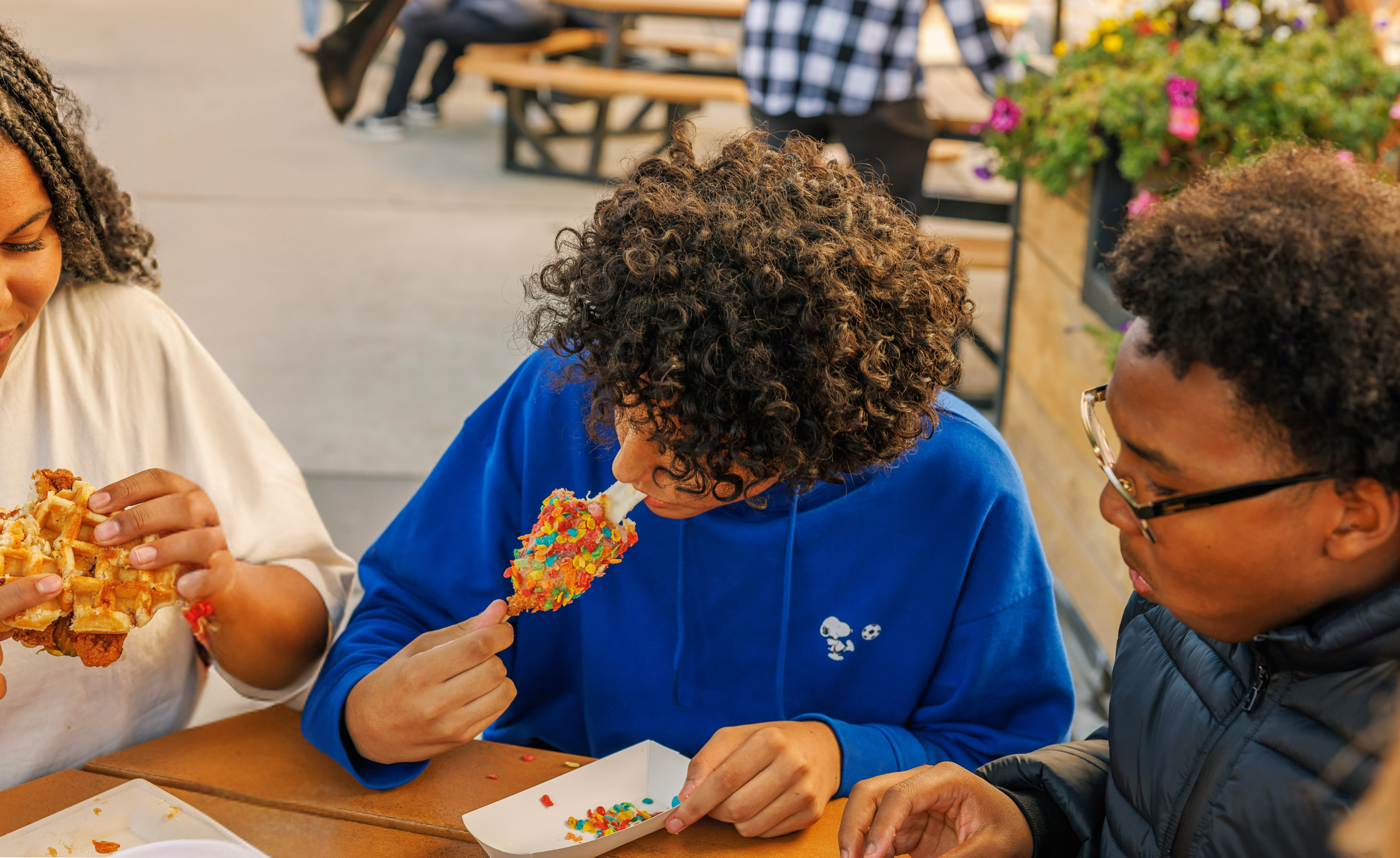 Friends enjoying colorful fair food at the Washington State Spring Fair in Puyallup