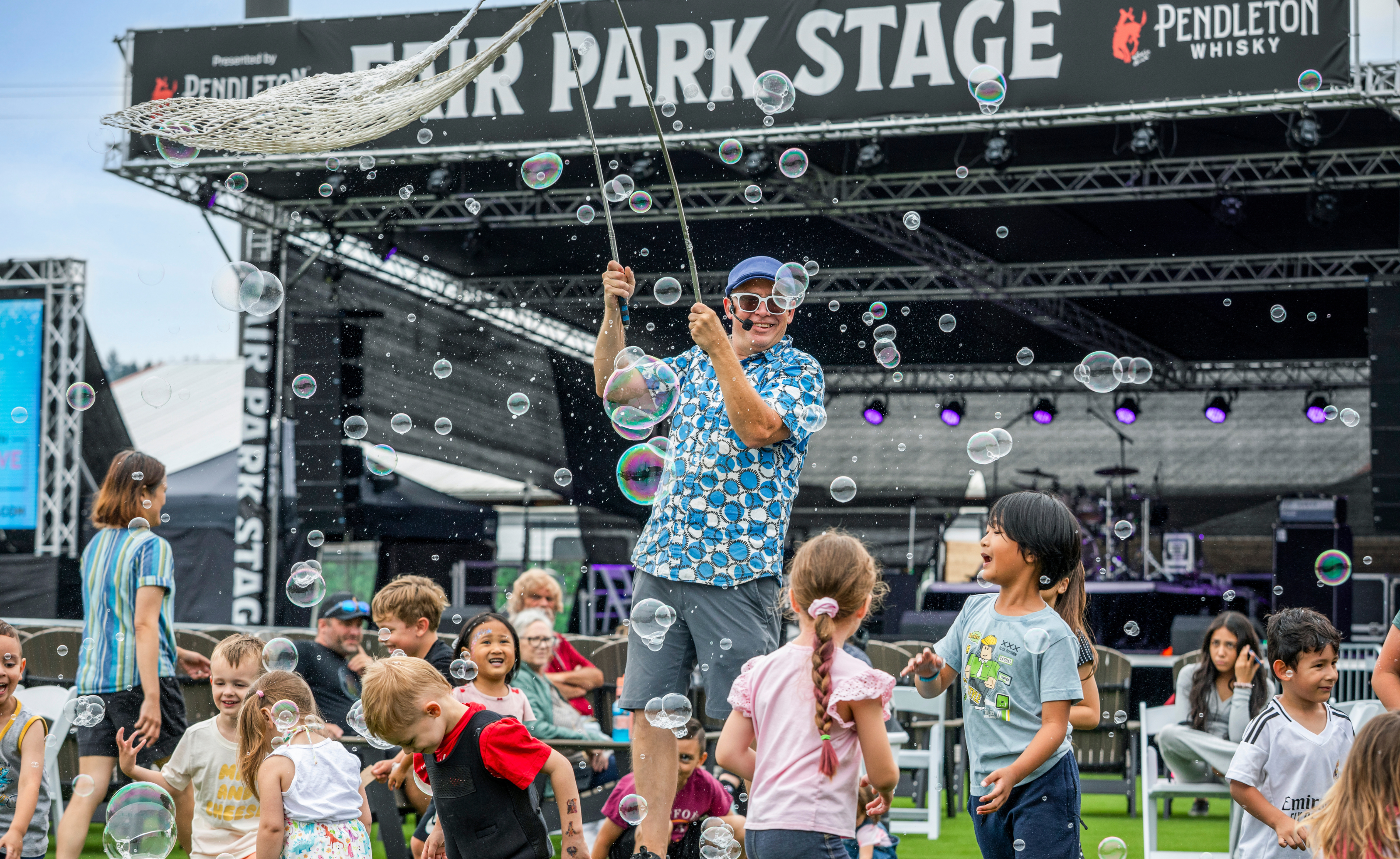 Families enjoying entertainment at Fair Park Stage during the Washington State Spring Fair
