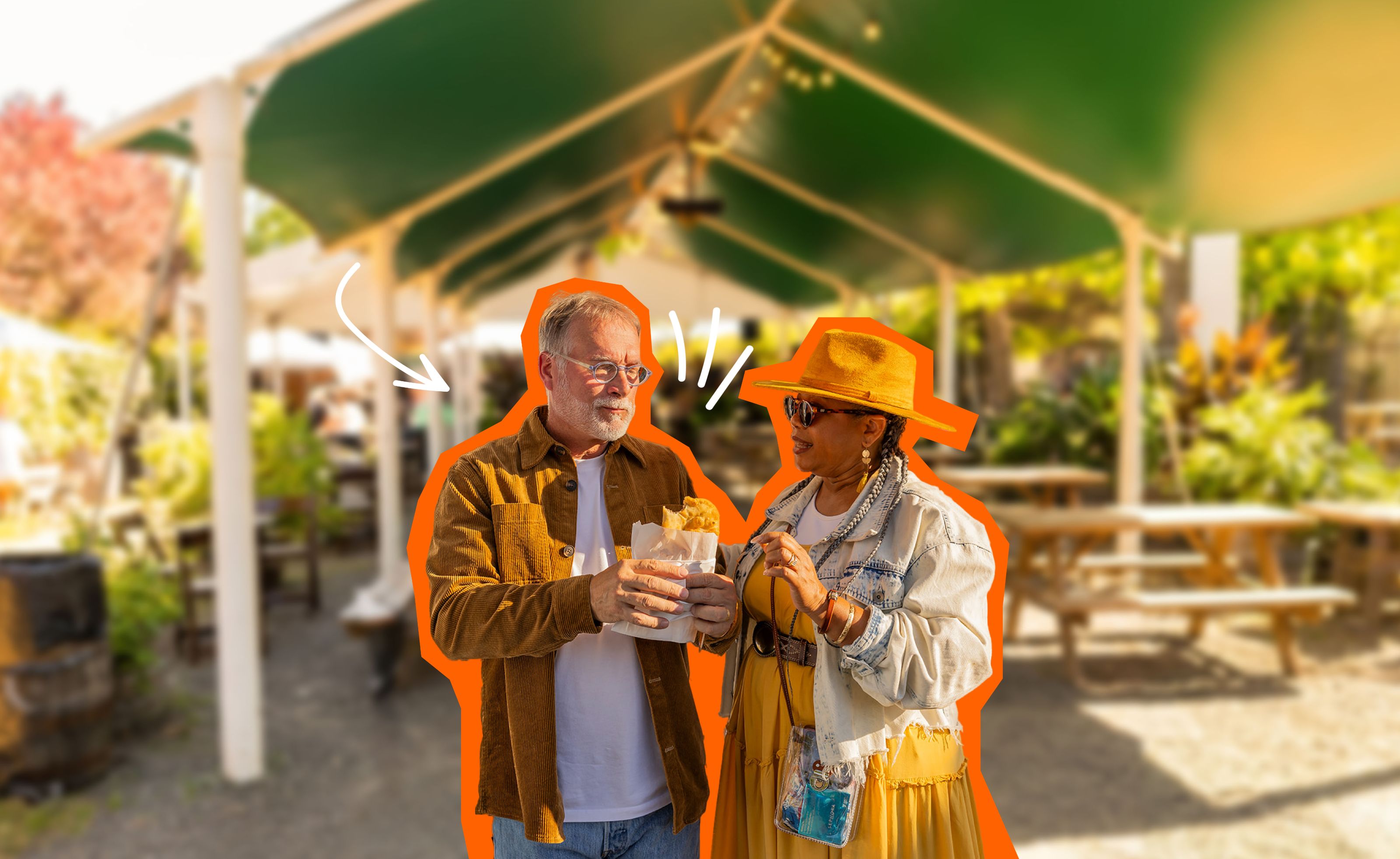 A couple enjoys delicious food in front of an outdoor setting.