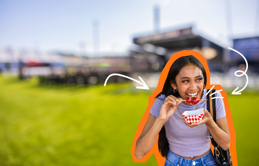 Girl eating tanghulu and smiling in a park setting