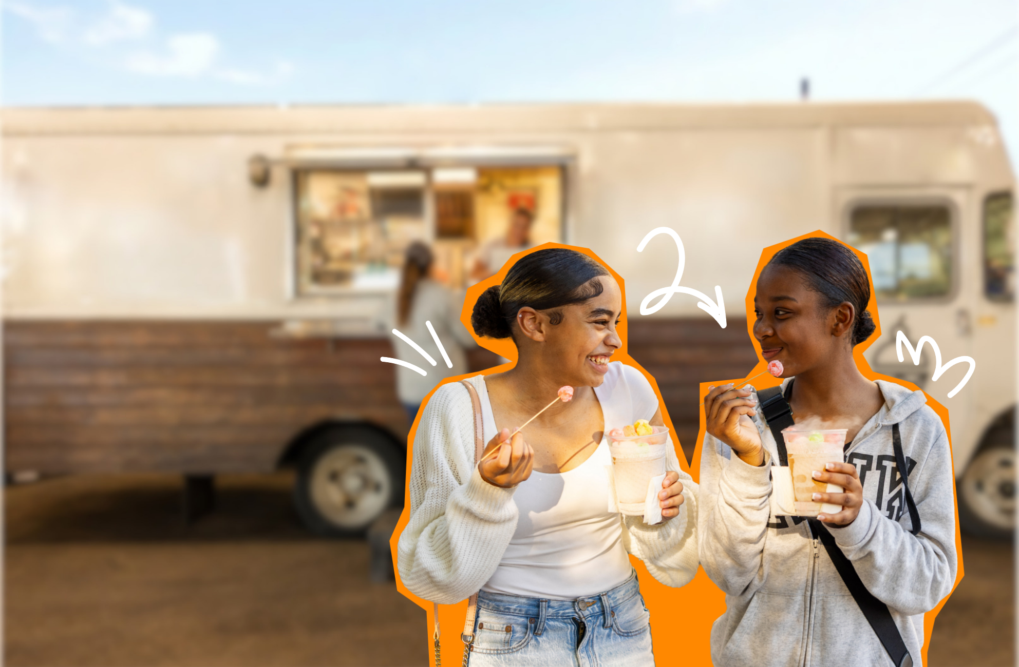 Two teens smiling at each other enjoy sparkling drinks with candy while standing in front of a food truck.