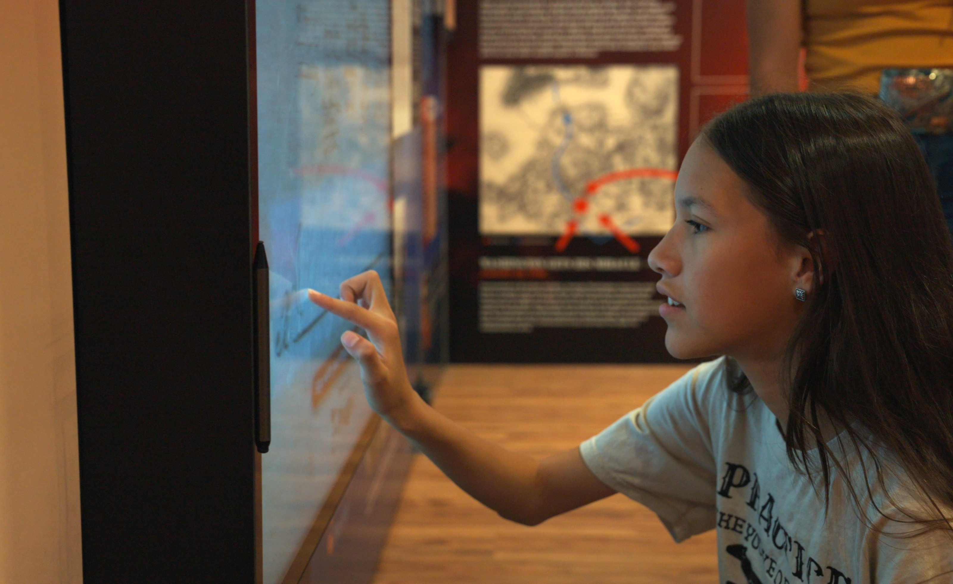 Girl Interacting with the exhibits in the Freedom Truck