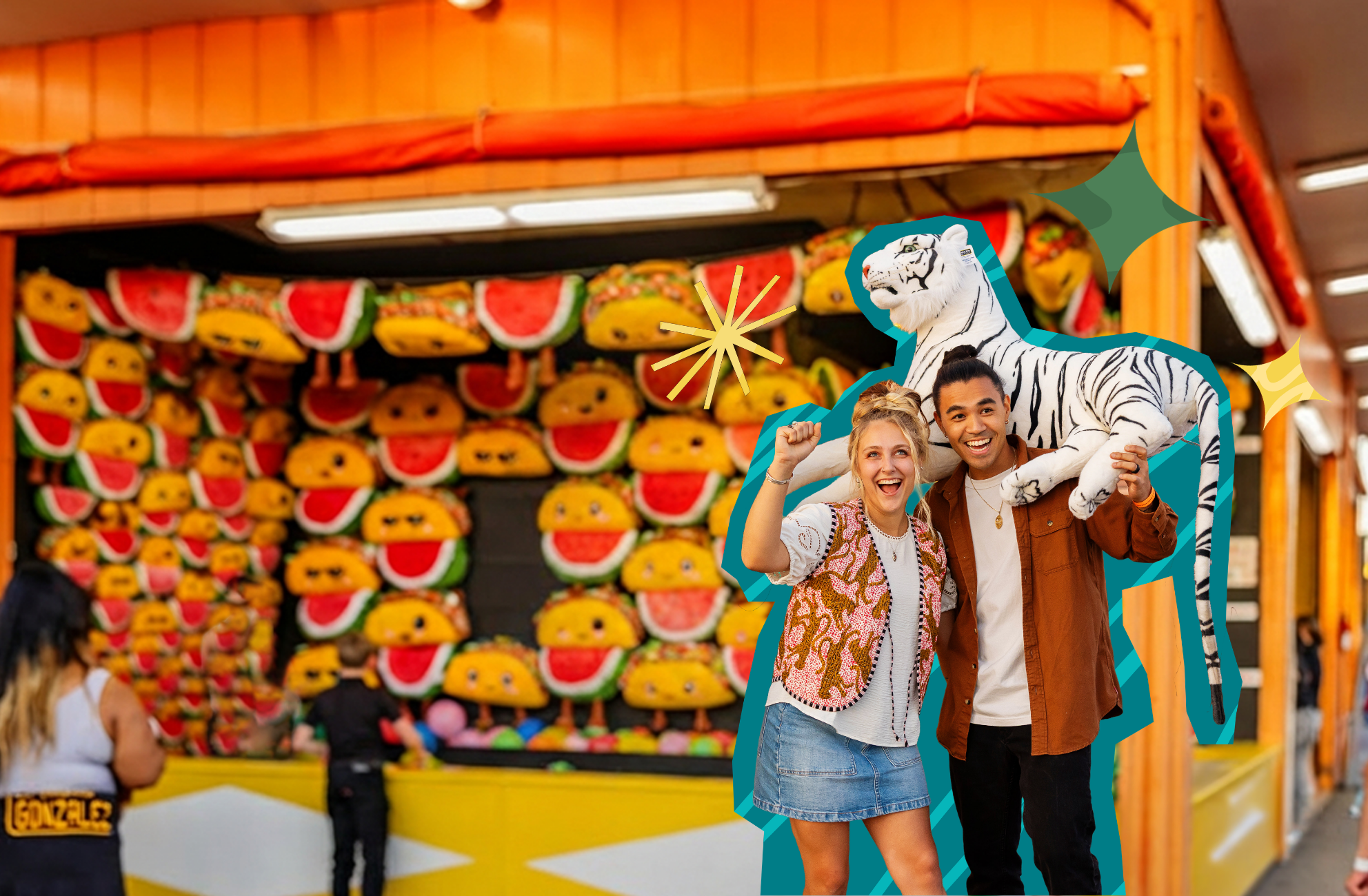 A couple holding up a prize plush tiger they won at a game booth.