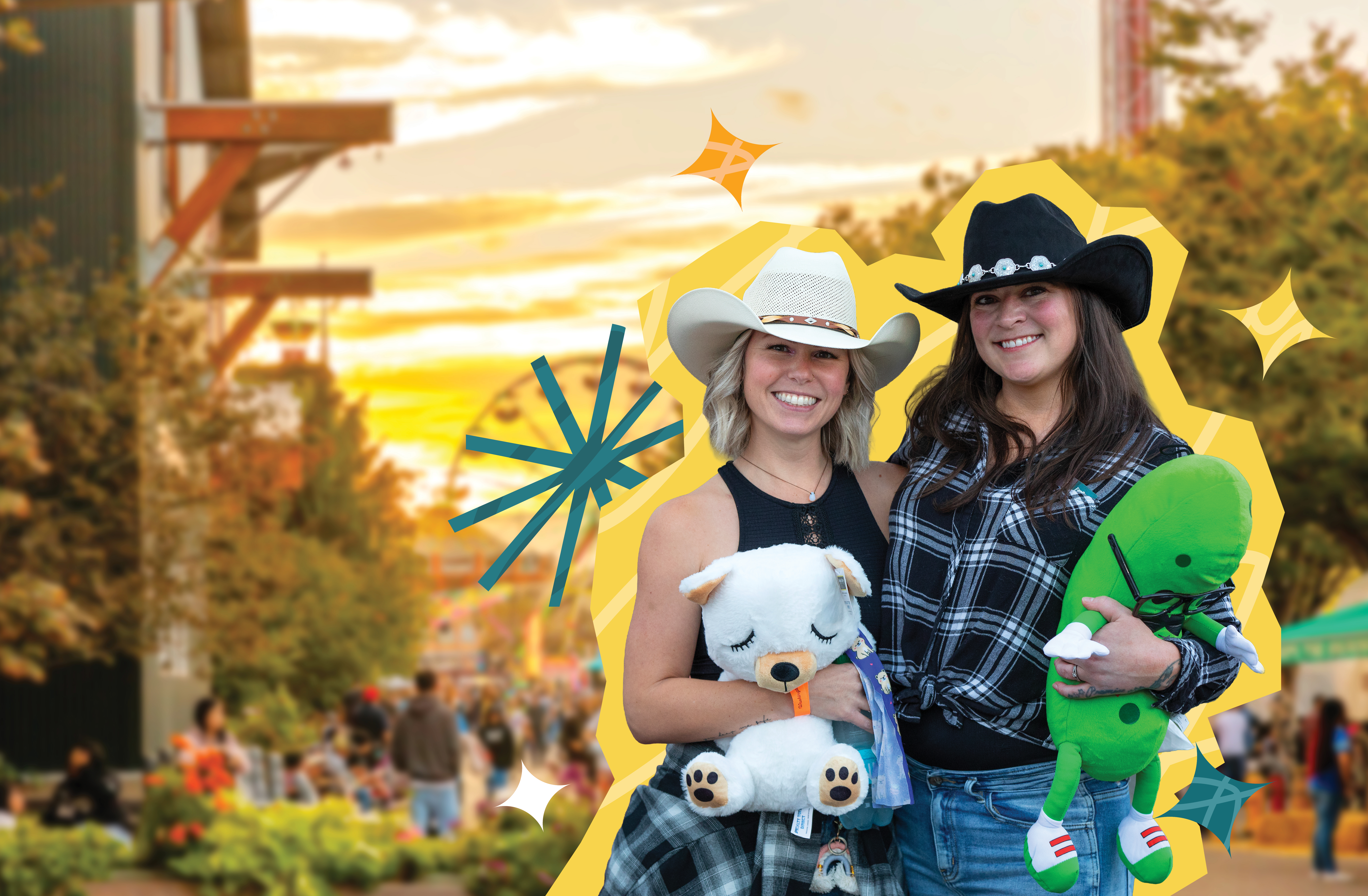 Two friends in black and white cowboy hats hold plushy toy prizes and smile at the camera with the sun setting over the midway in the background.