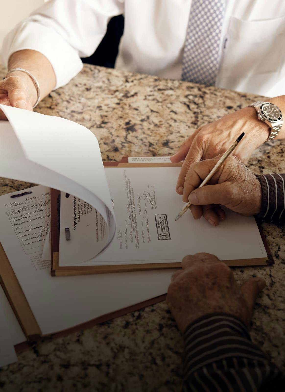 People reviewing a document to sign