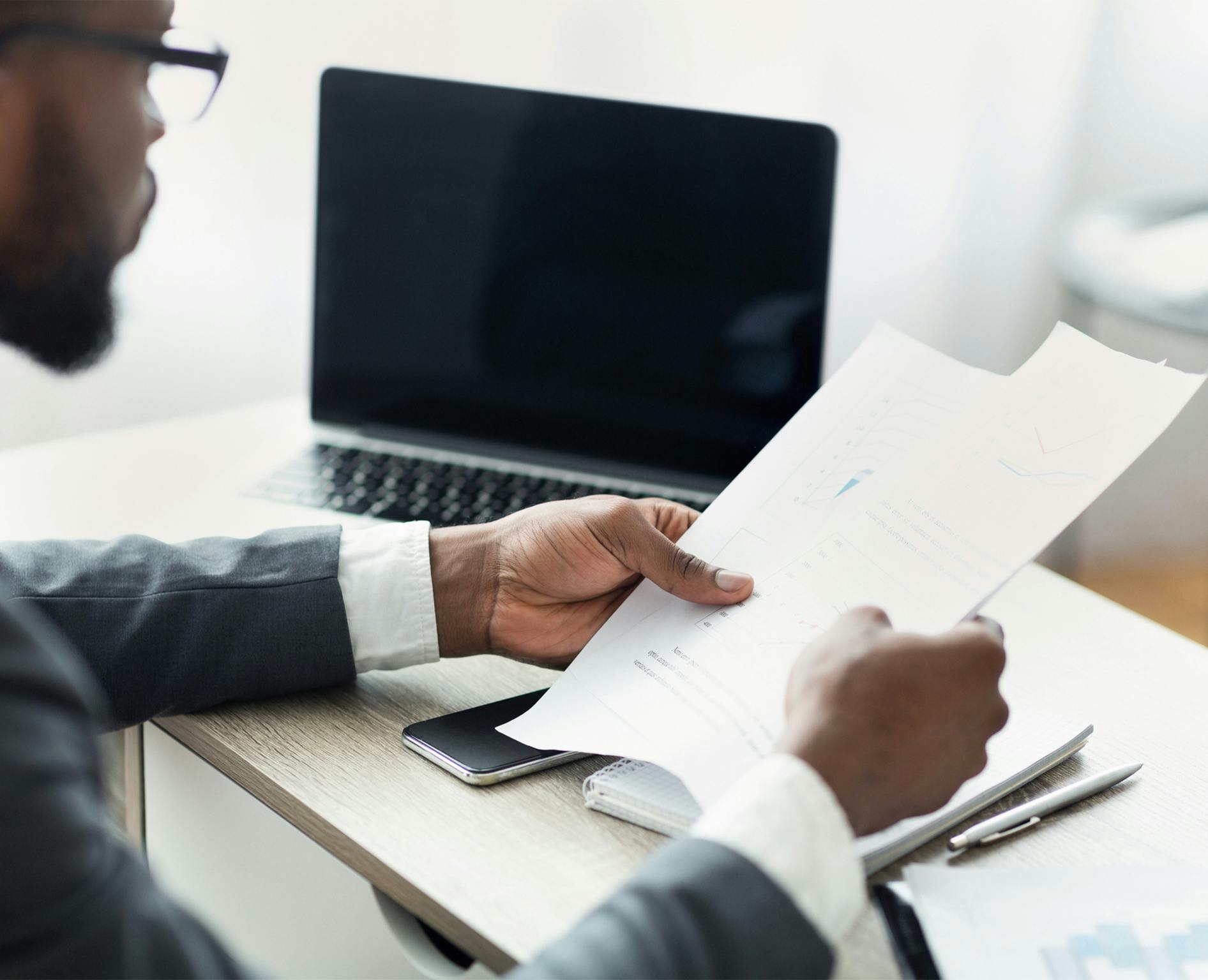 person looking at papers at a desk