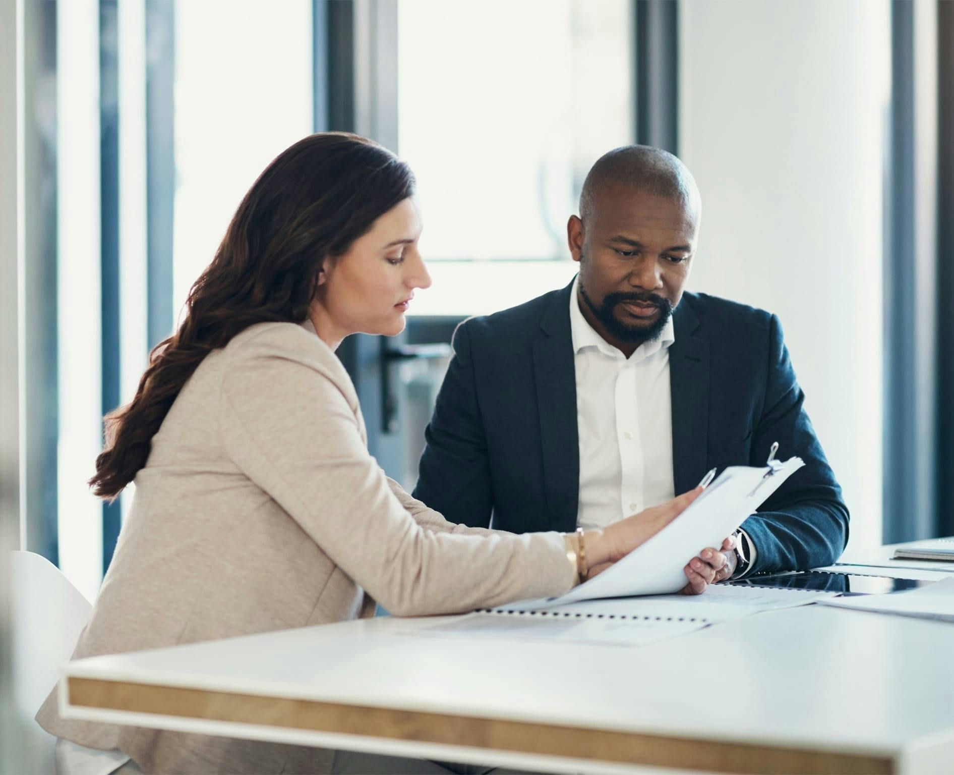 Man and woman looking at papers