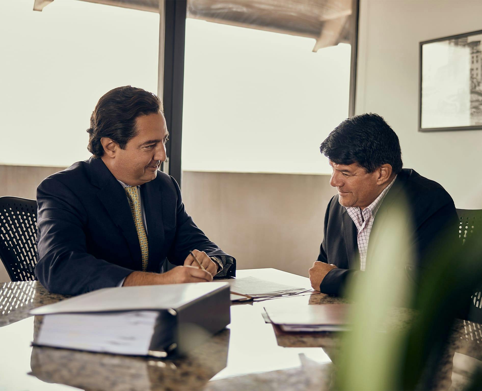 two men looking at paper