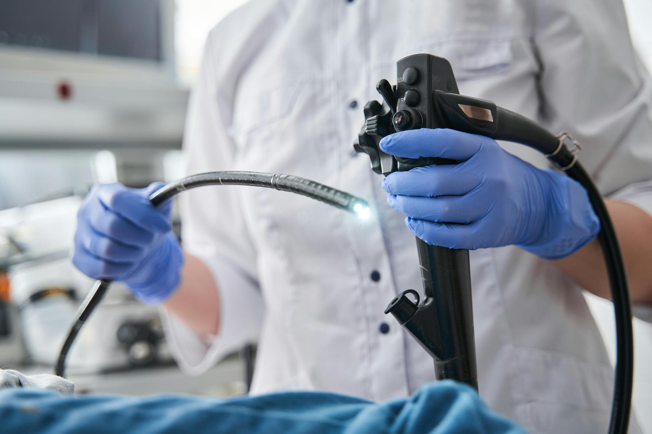 Medical professional holding a reusable endoscope