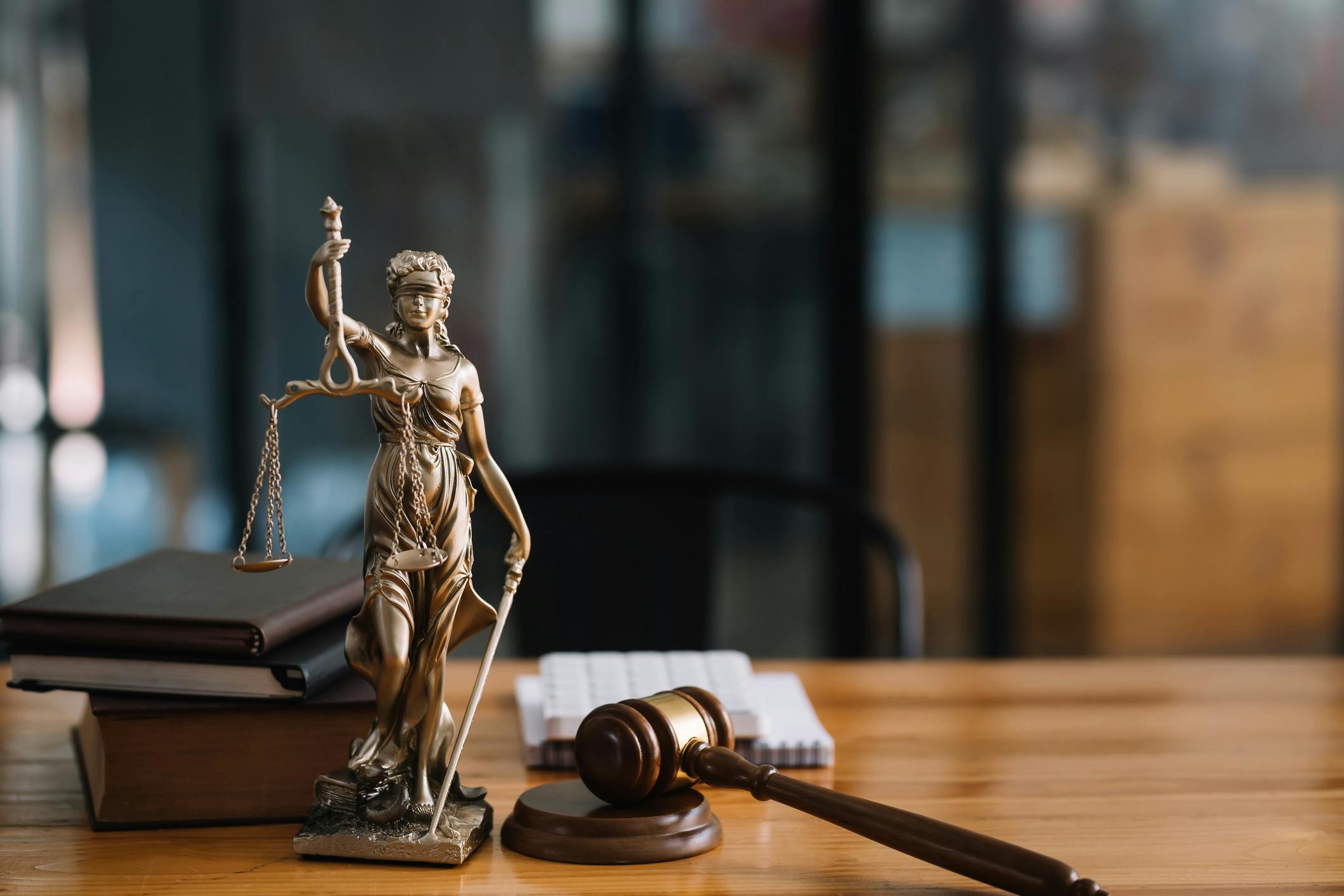 Lady Justice statue and gavel on an attorney desk