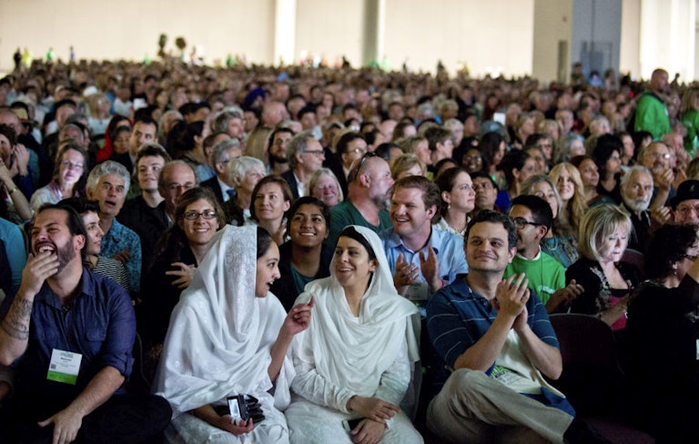 In this photo taken on Thursday, Oct. 15, 2015, people listen as Imam Malik Mujahid, chairman for the Parliament of the World's Religions, speaks during the opening plenary of the 2015 Parliament of the World's Religions held inside the Salt Palace Convention Center in Salt Lake City. Visitors from 80 countries and 50 different religions arrived in Salt Lake City to attend the interfaith conference being held in the United States for the first time since 1993. (Lennis Mahler/The Salt Lake Tribune via AP)