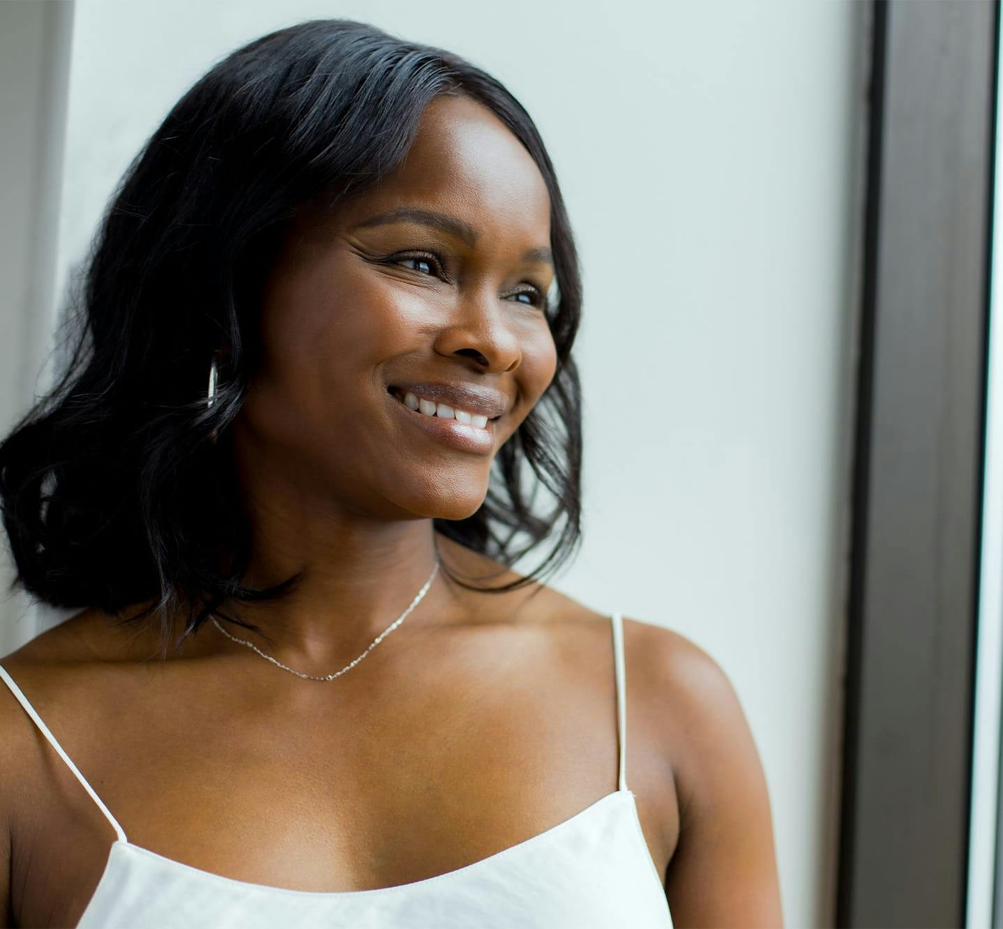 woman smiling looking out window