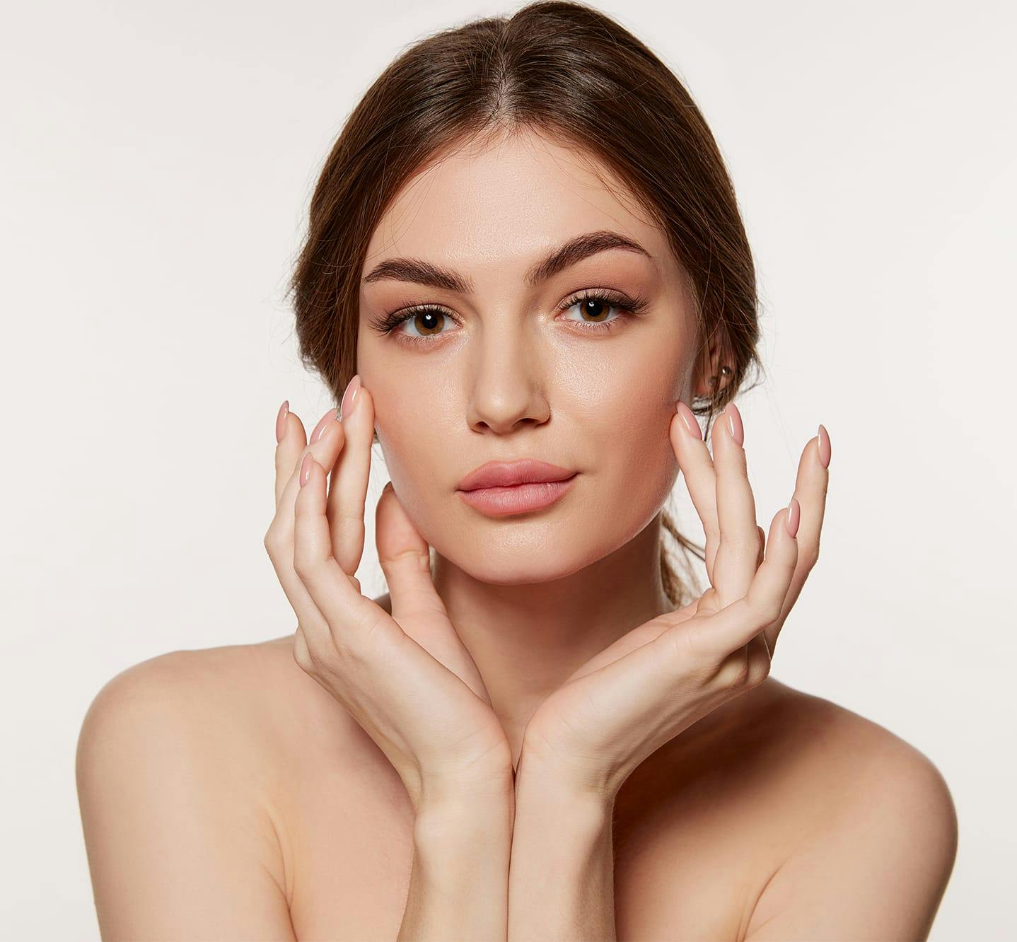 woman touching the sides of her face