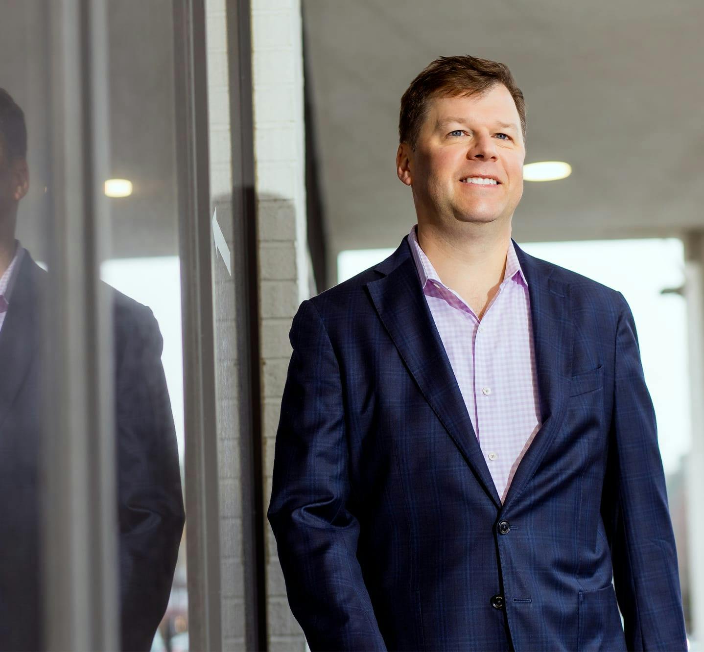 Dr Melson standing next to Sherman Aesthetics building