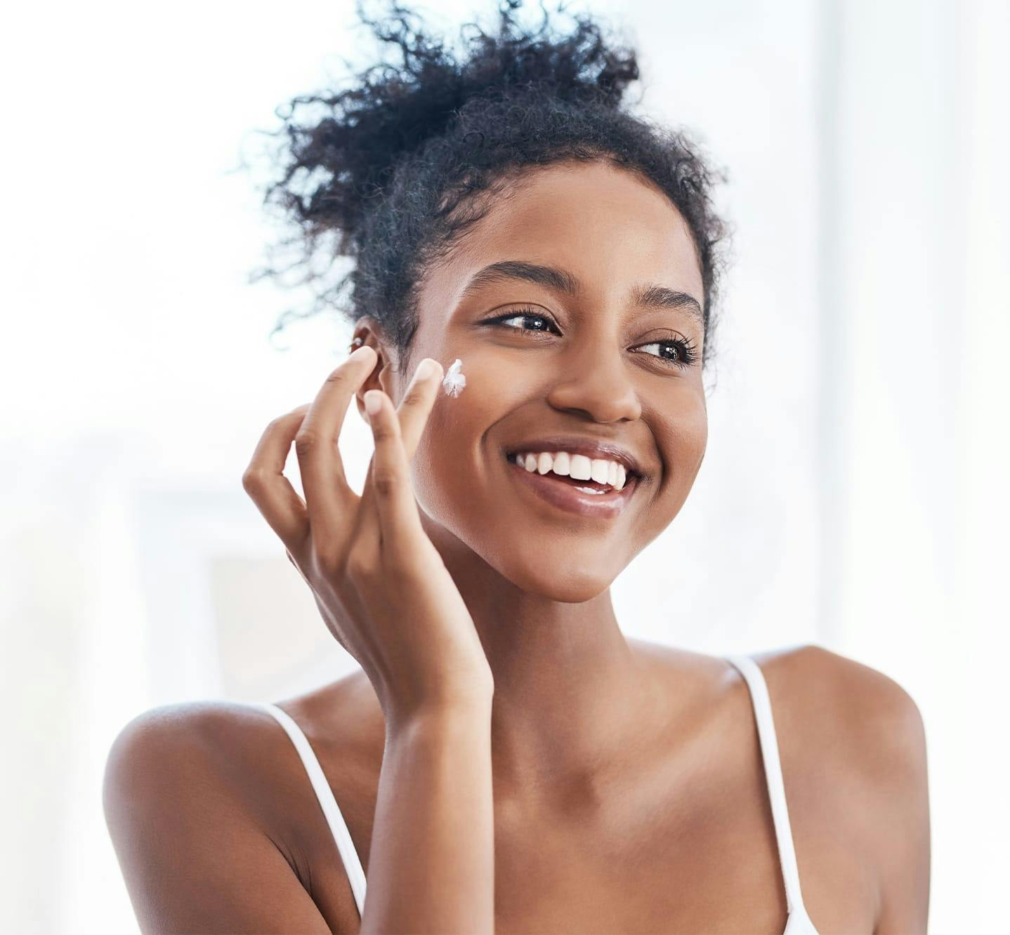 smiling woman applying makeup