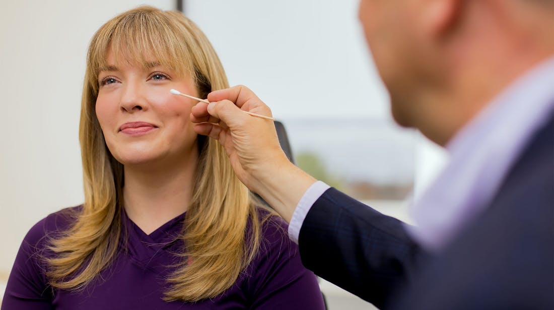 doctor swabbing lower eyelid