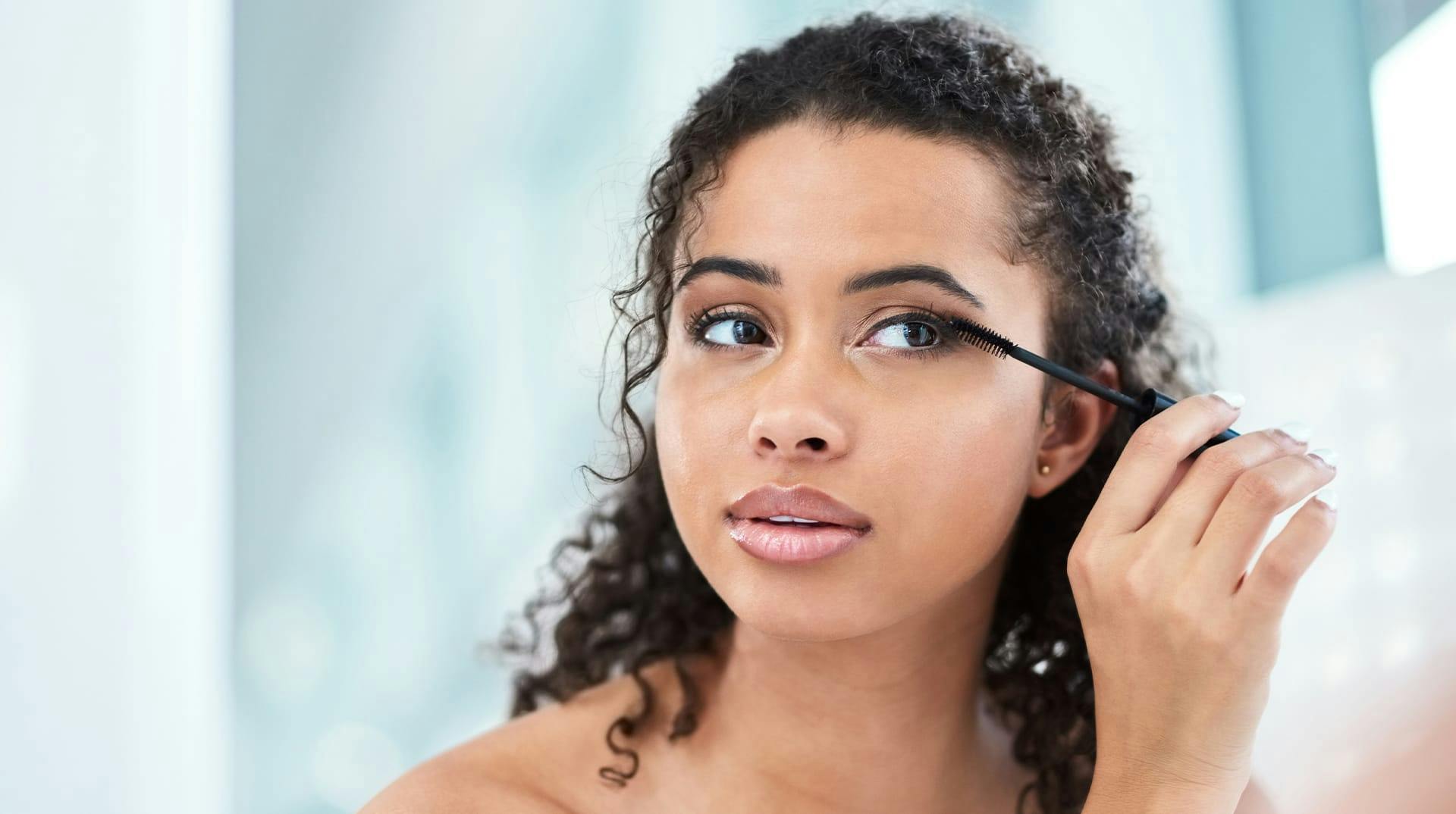 woman applying eye product