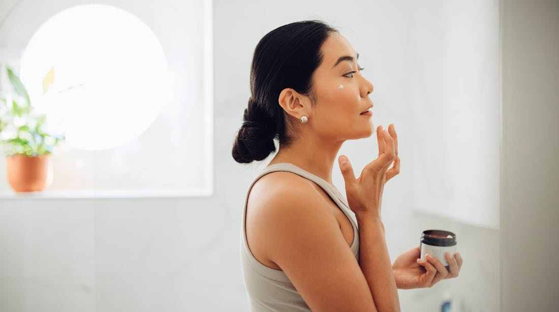 woman applying skin product