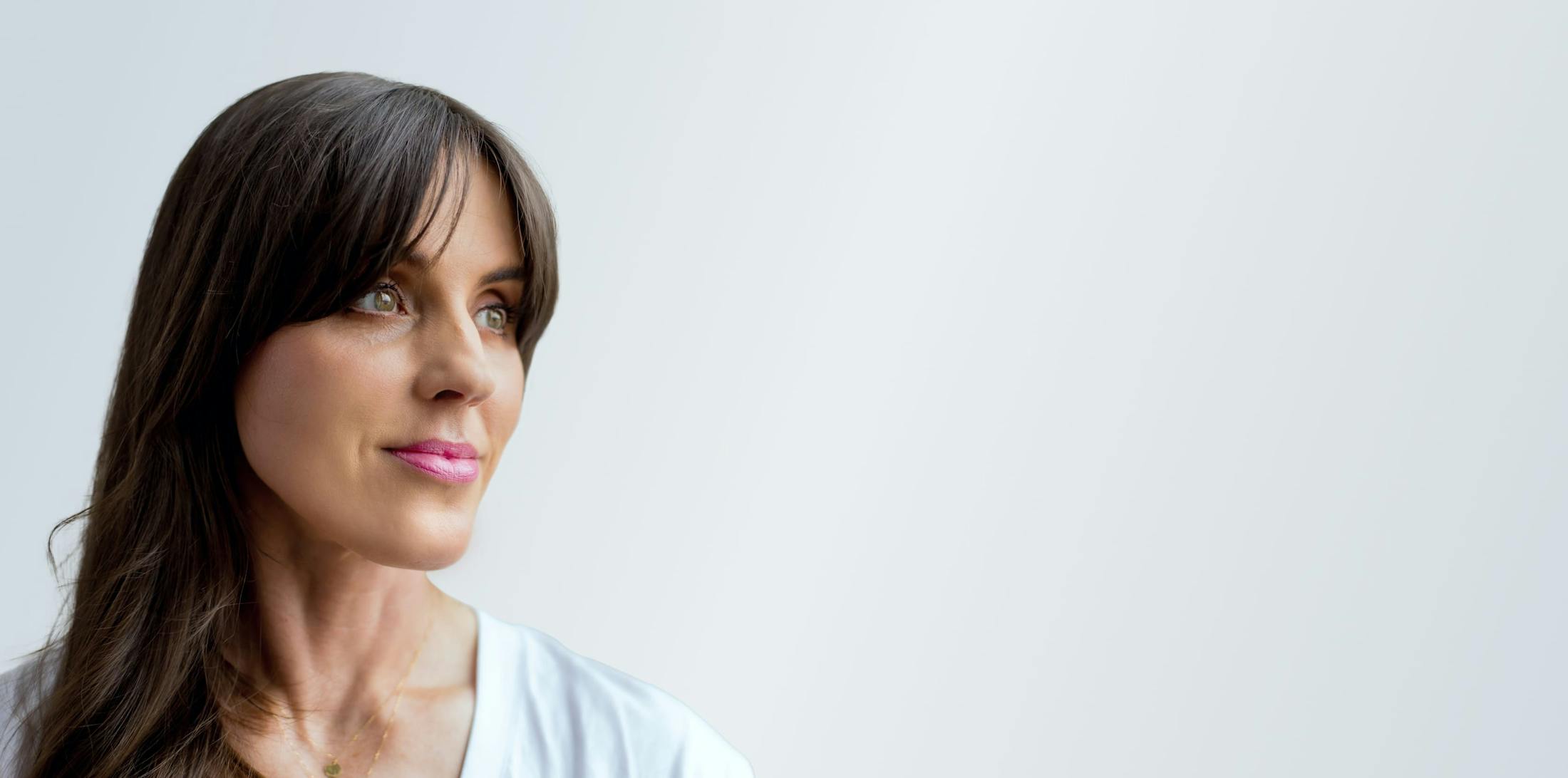 woman with long brown hair with bangs