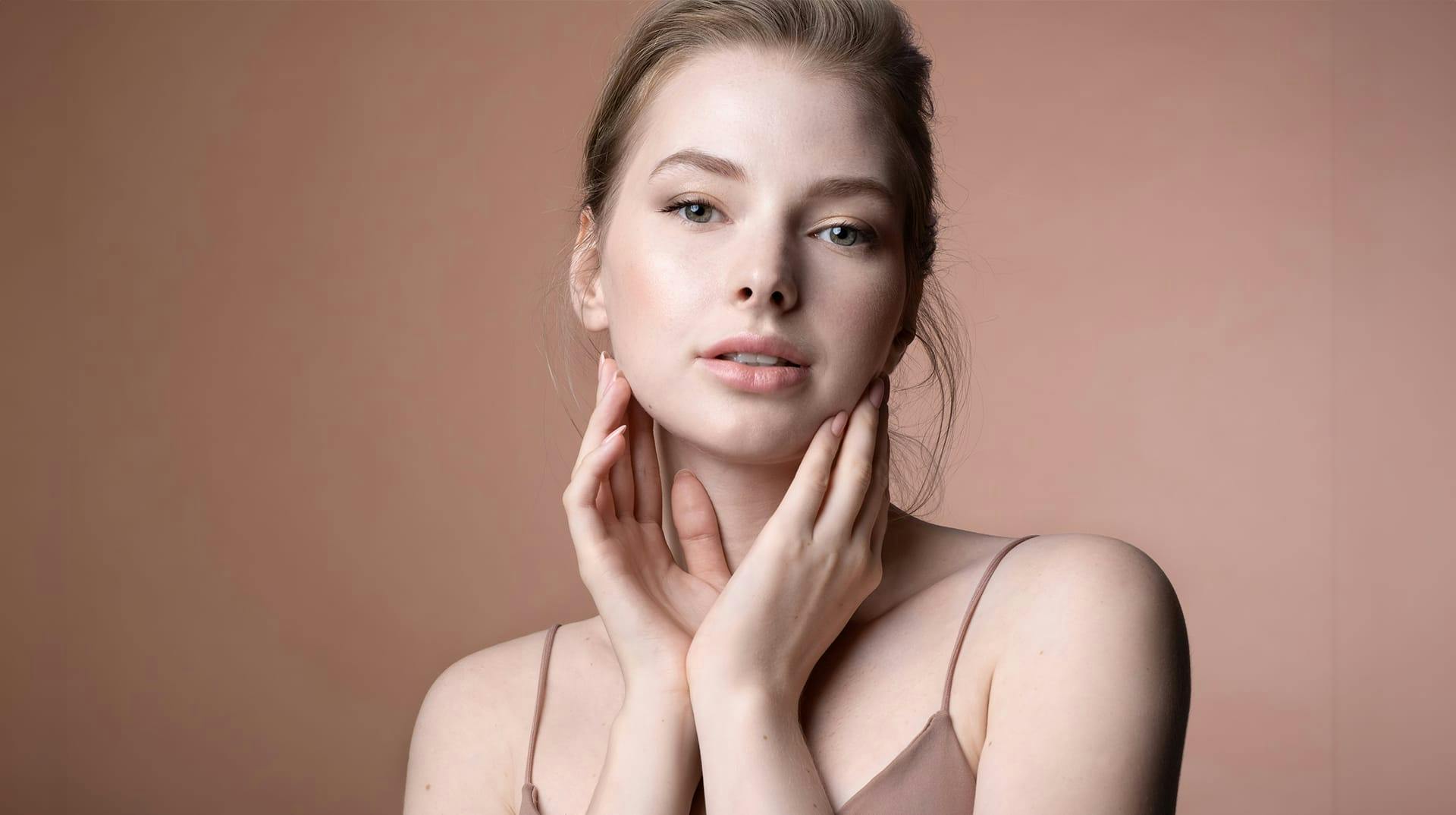 woman touching sides of face